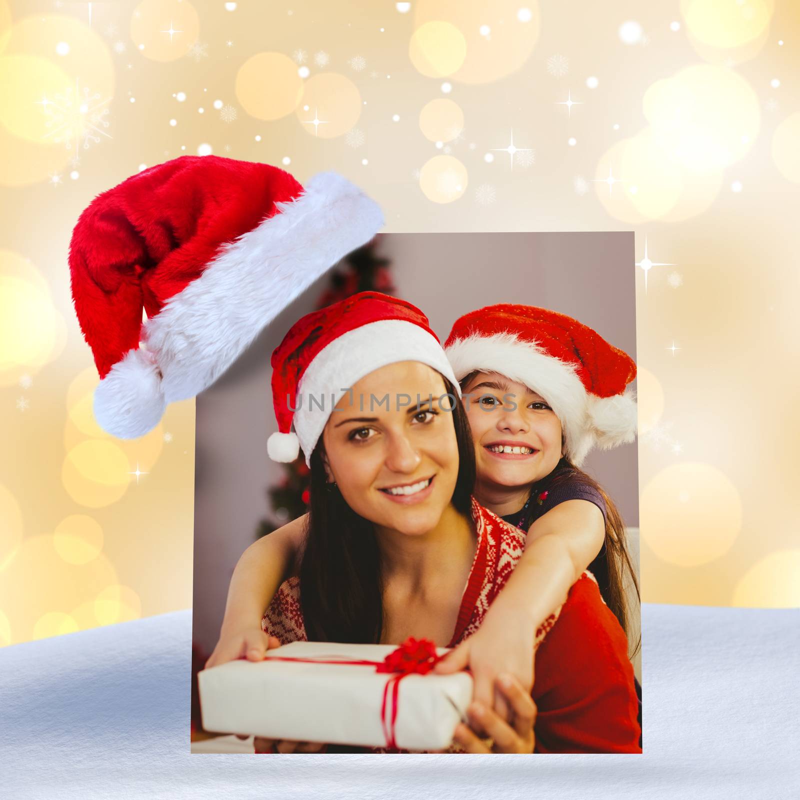 Festive mother and daughter smiling at camera against yellow abstract light spot design