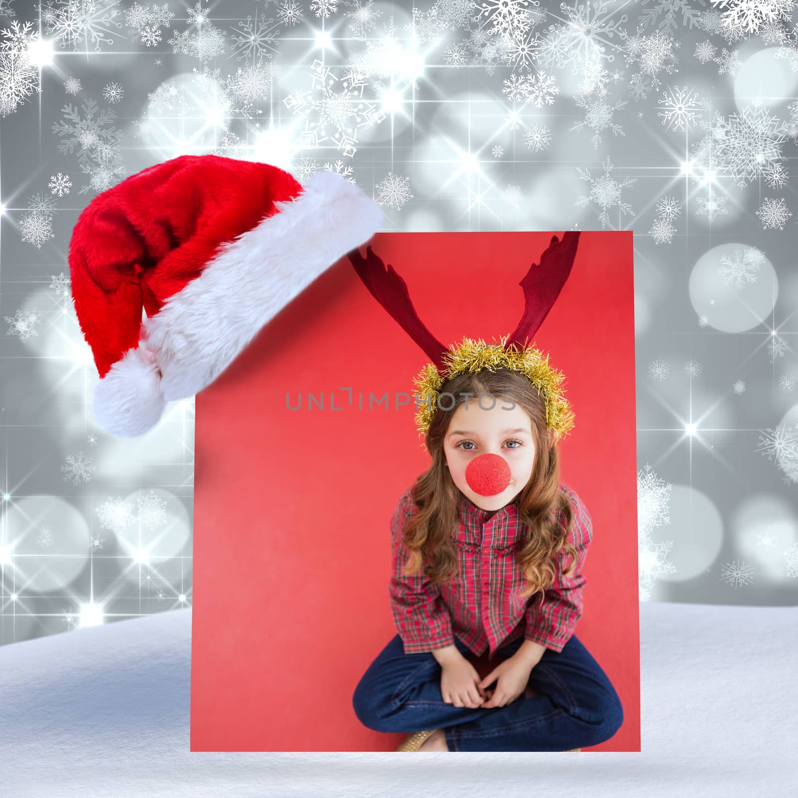 Composite image of festive little girl wearing red nose by Wavebreakmedia