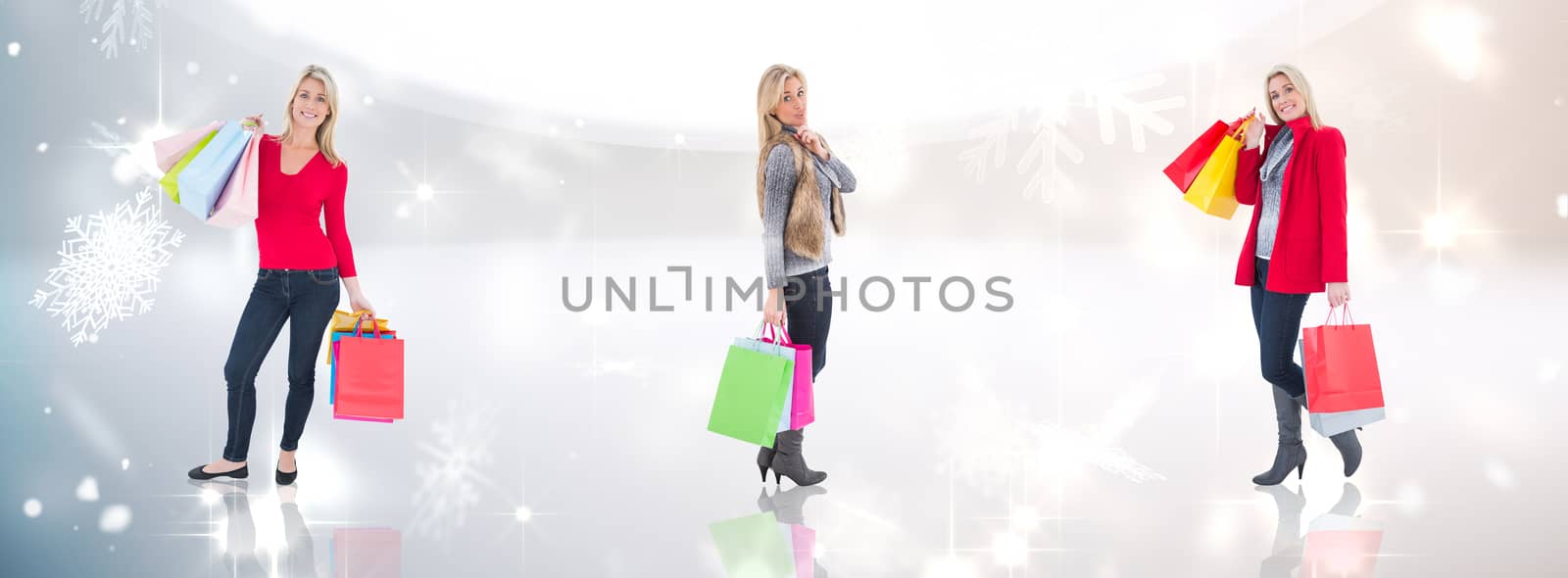 Happy blonde holding shopping bags against lights twinkling in modern room