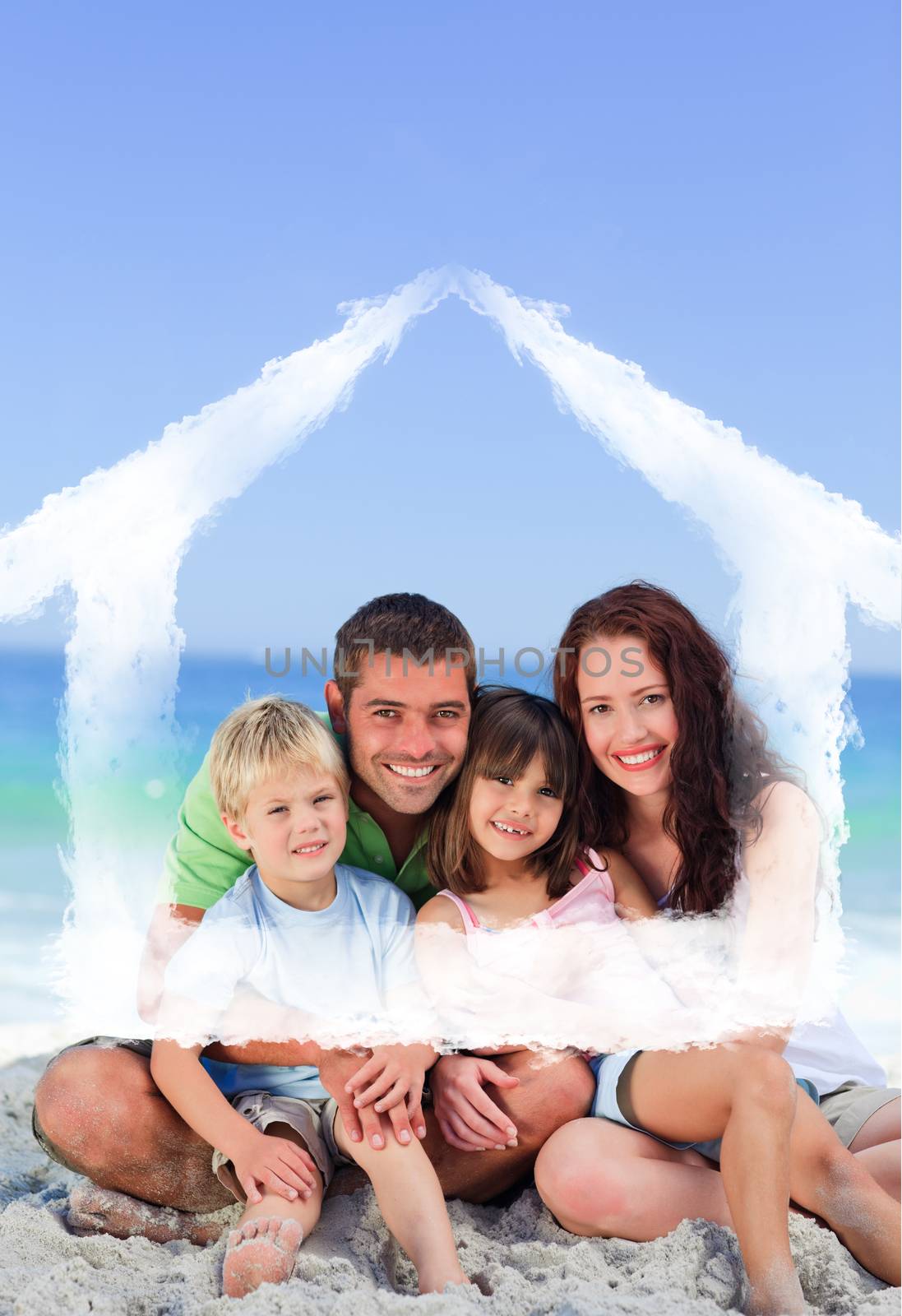 Portrait of a family at the beach against house outline in clouds