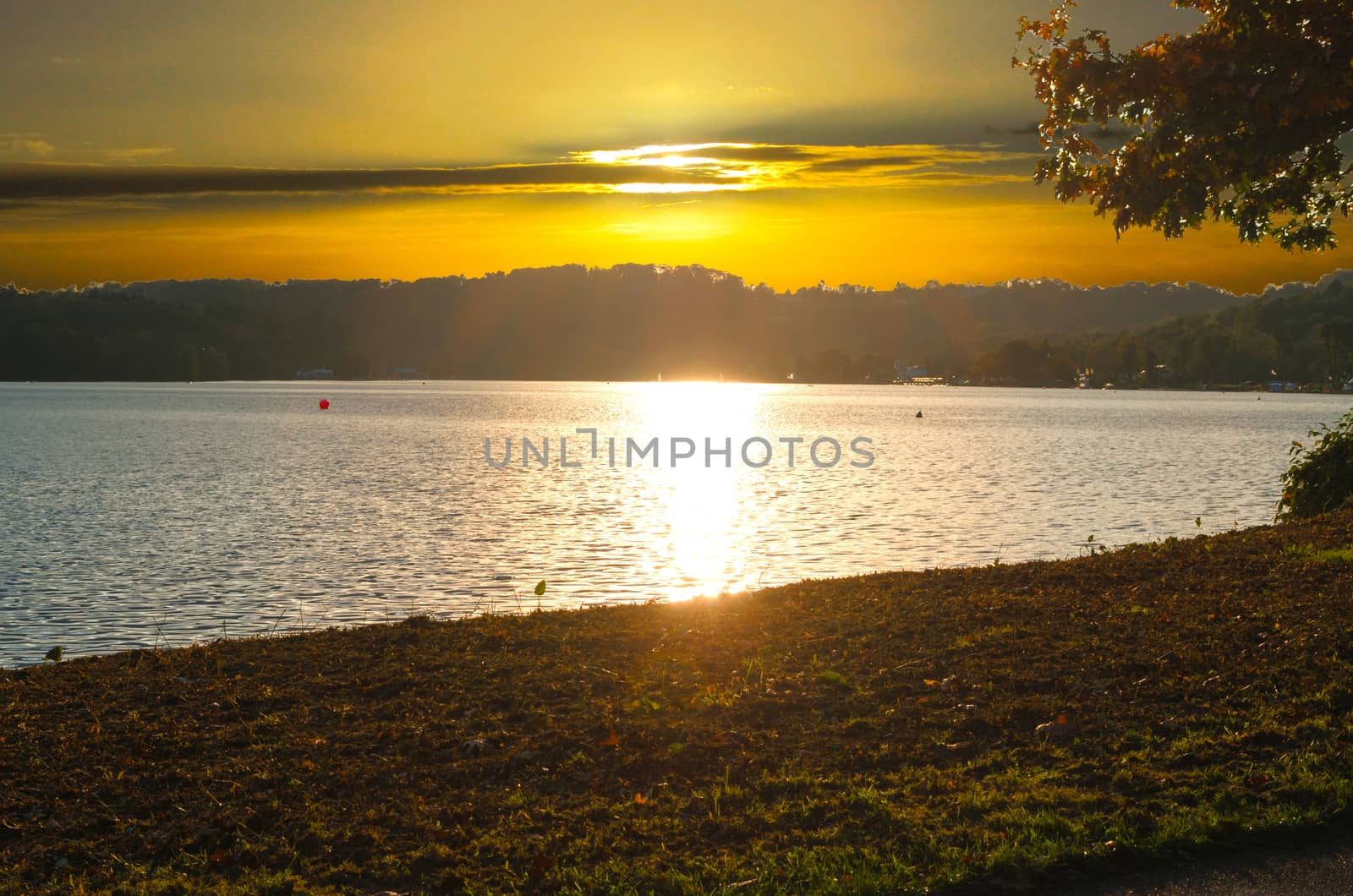 A beautiful sunset with reflection of the sun in the lake.