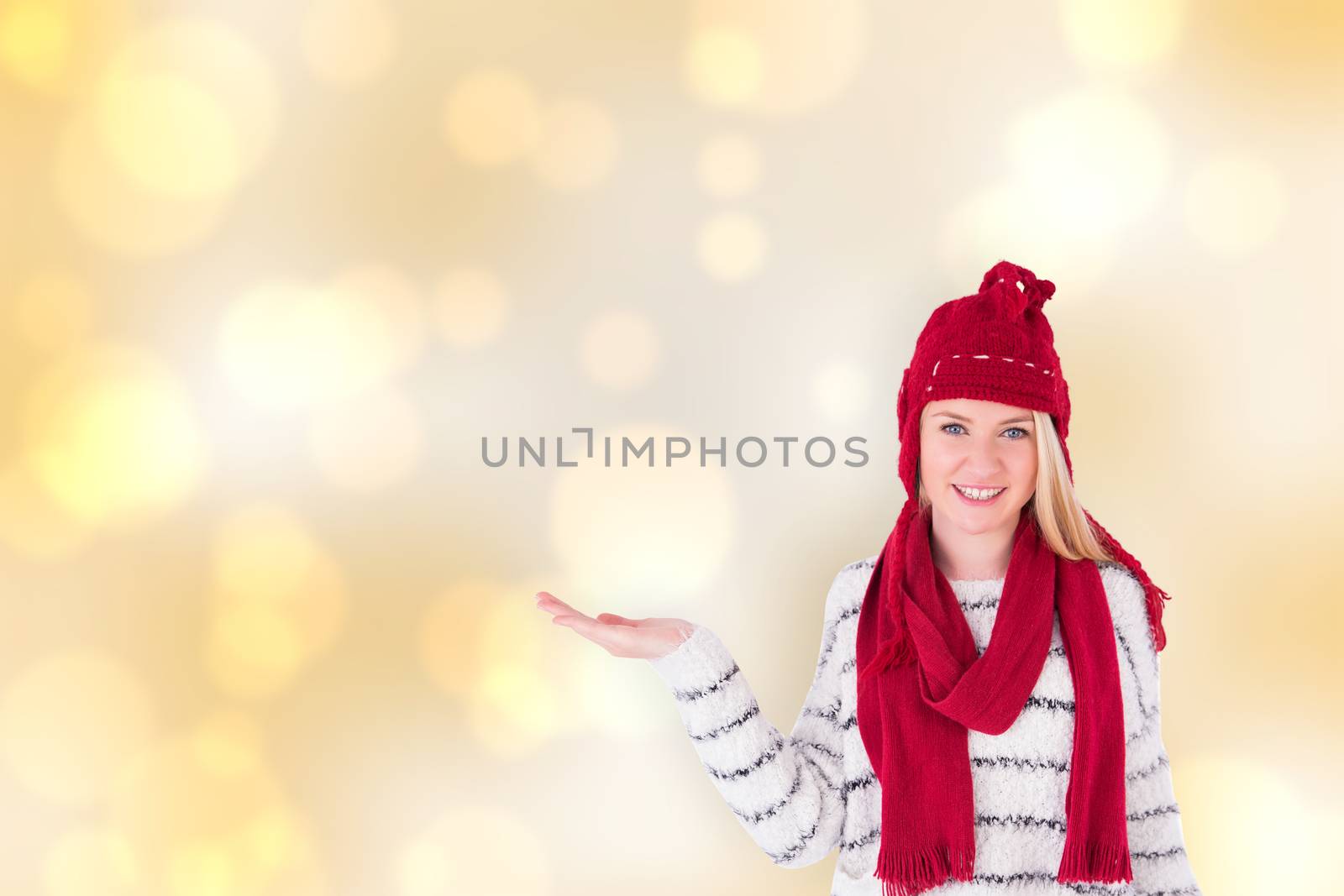 Festive blonde presenting with hand against yellow abstract light spot design