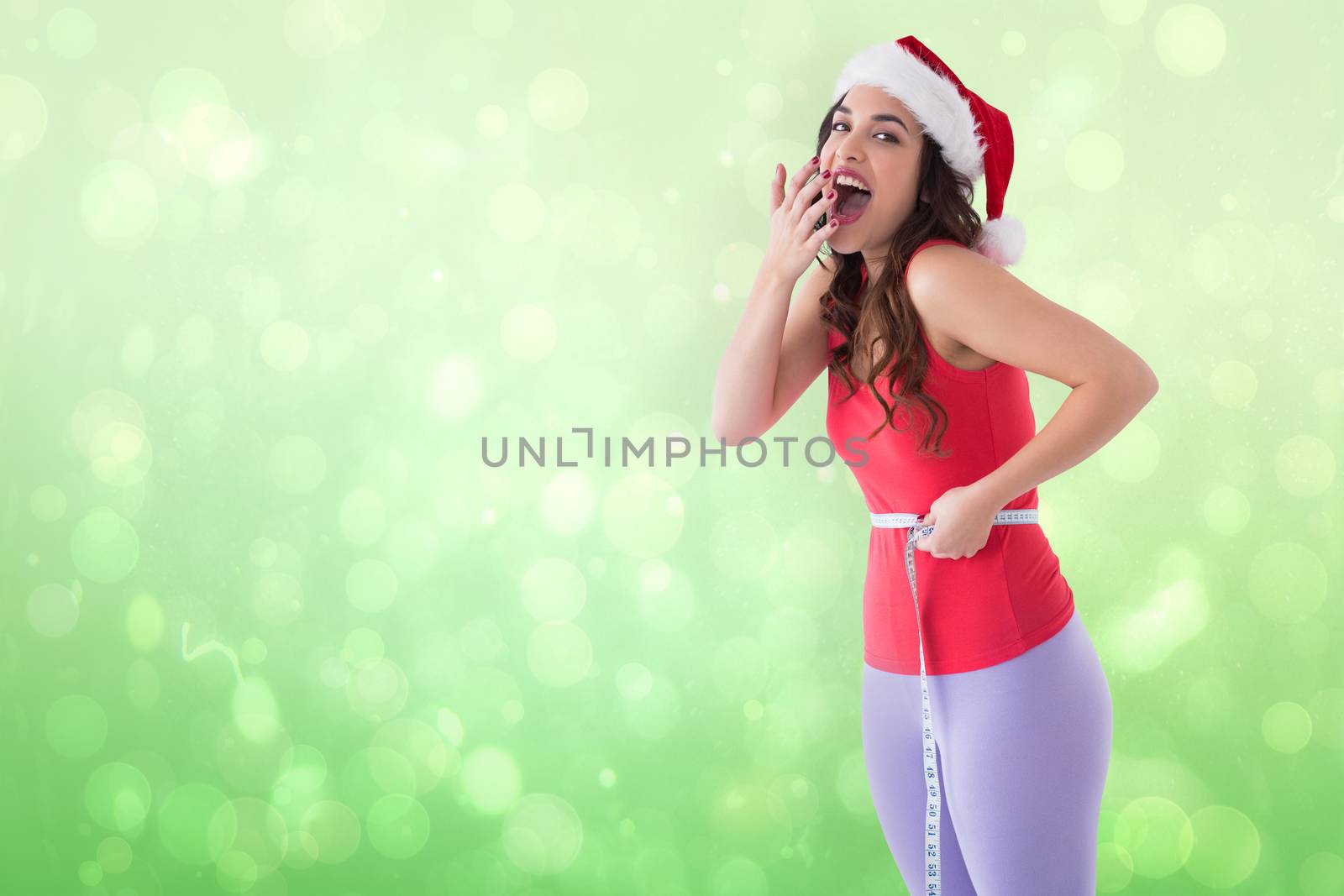 Composite image of positive brunette measuring her waist  by Wavebreakmedia