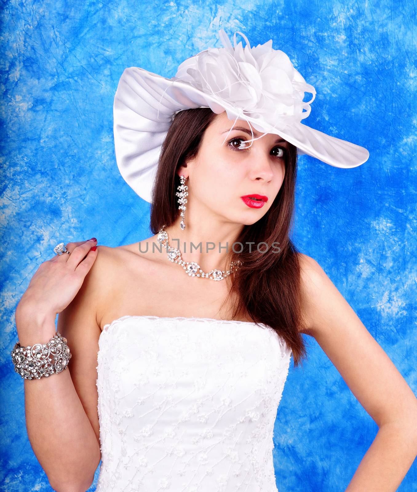 young girl in a wedding dress and hat