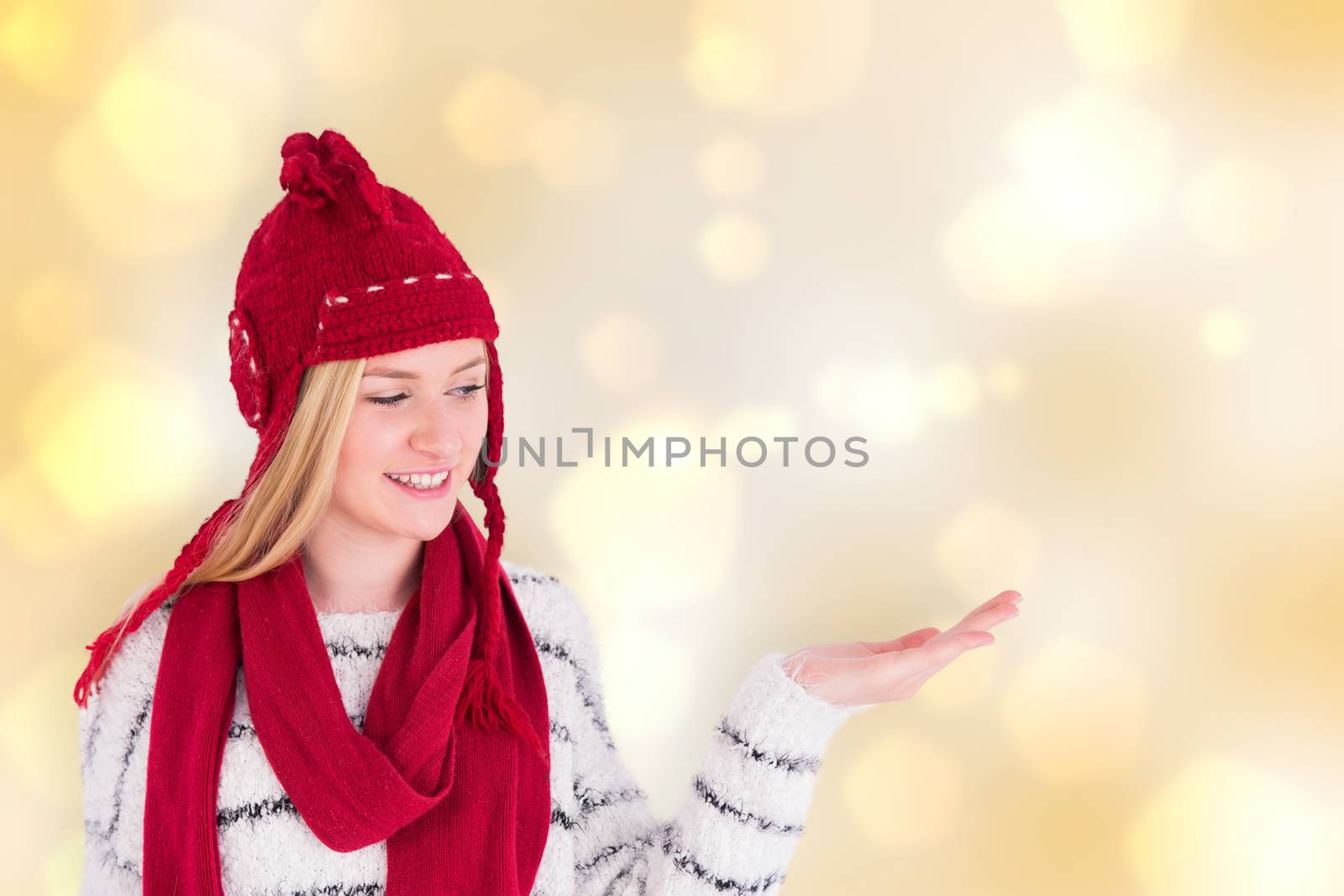 Composite image of festive blonde presenting with hand by Wavebreakmedia