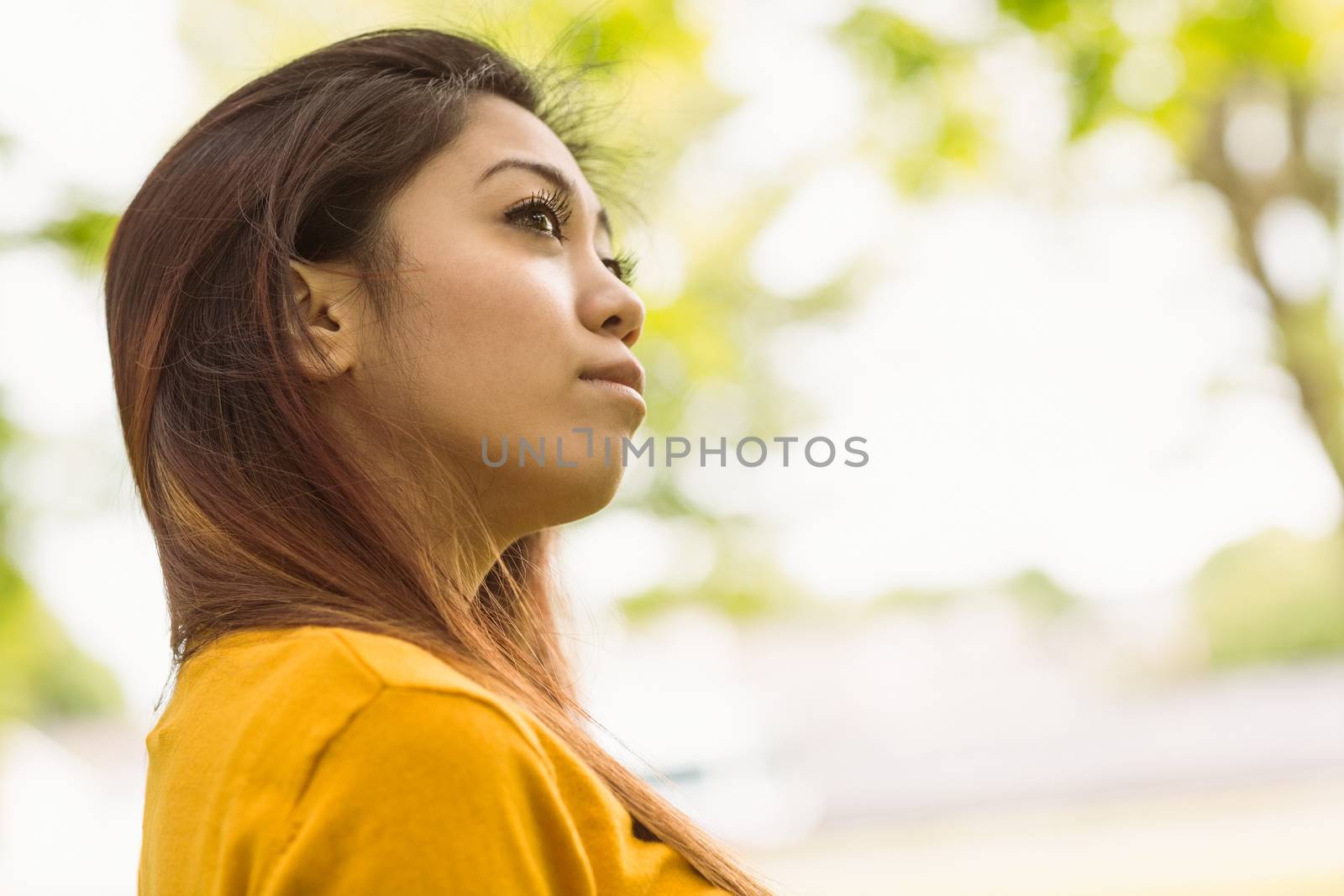 Beautiful young woman looking away outdoors