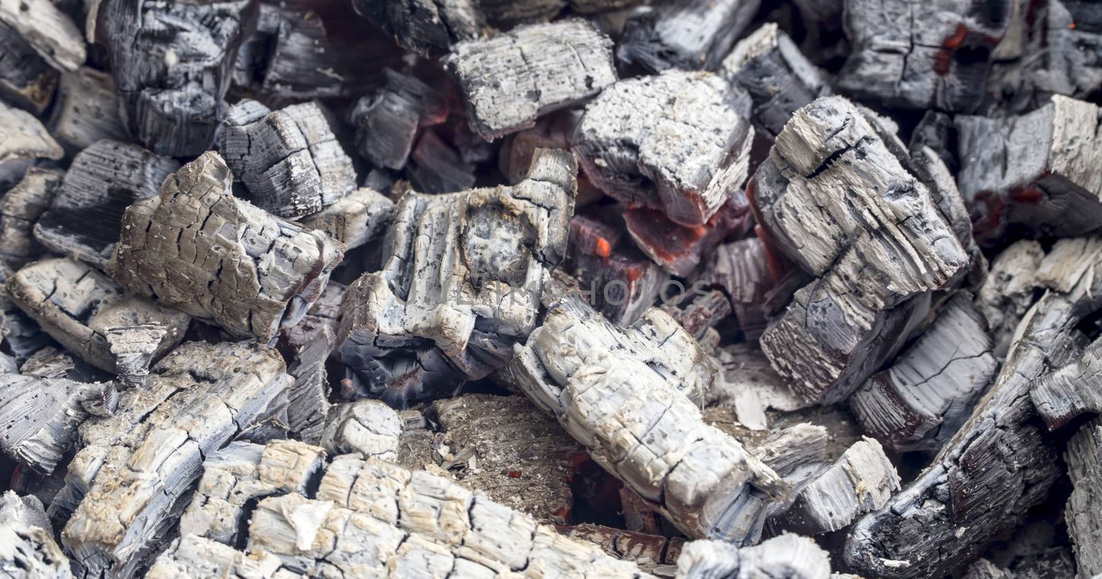 burning charcoal in the background closeup isolated