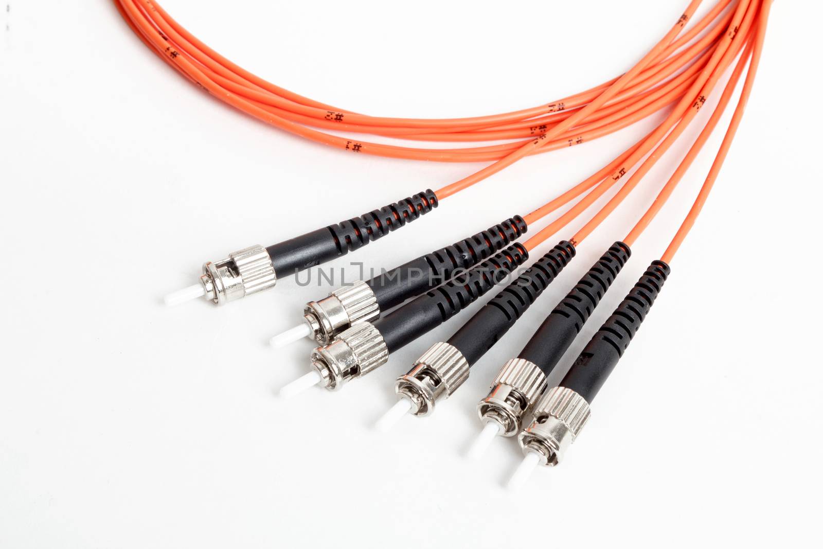 group of fiber optic ST connectors on orange patchcord 