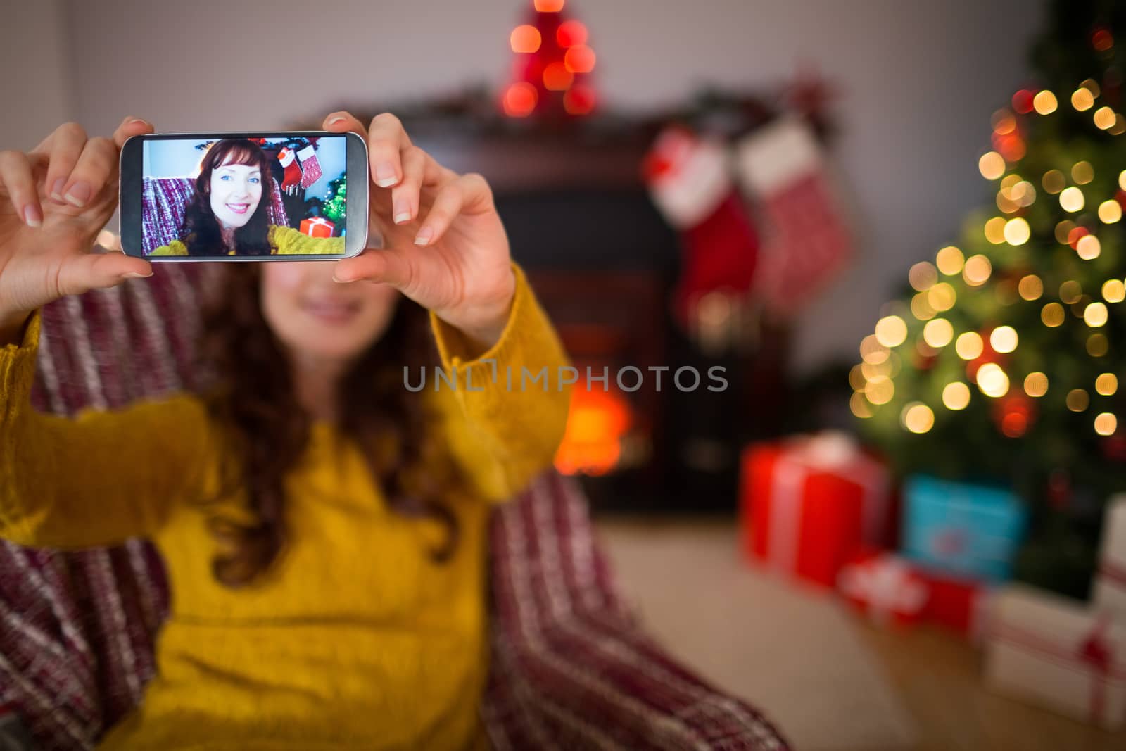 Beauty redhead taking a selfie at christmas at home in the living room