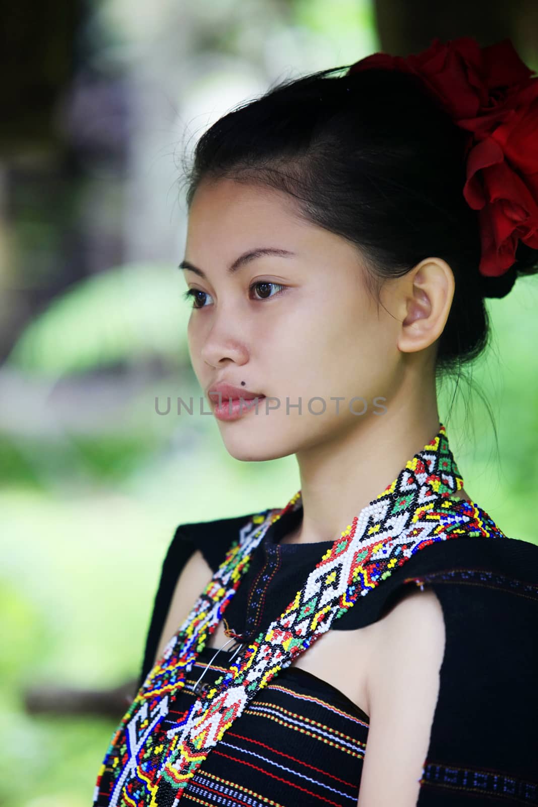 Kota Kinabalu, Sabah, Malaysia - January 04, 2015: Girl in ancient traditional clothing from Cultural Village Mari Mari is a living museum located in Inanam, Sabah Borneo, Malaysia.