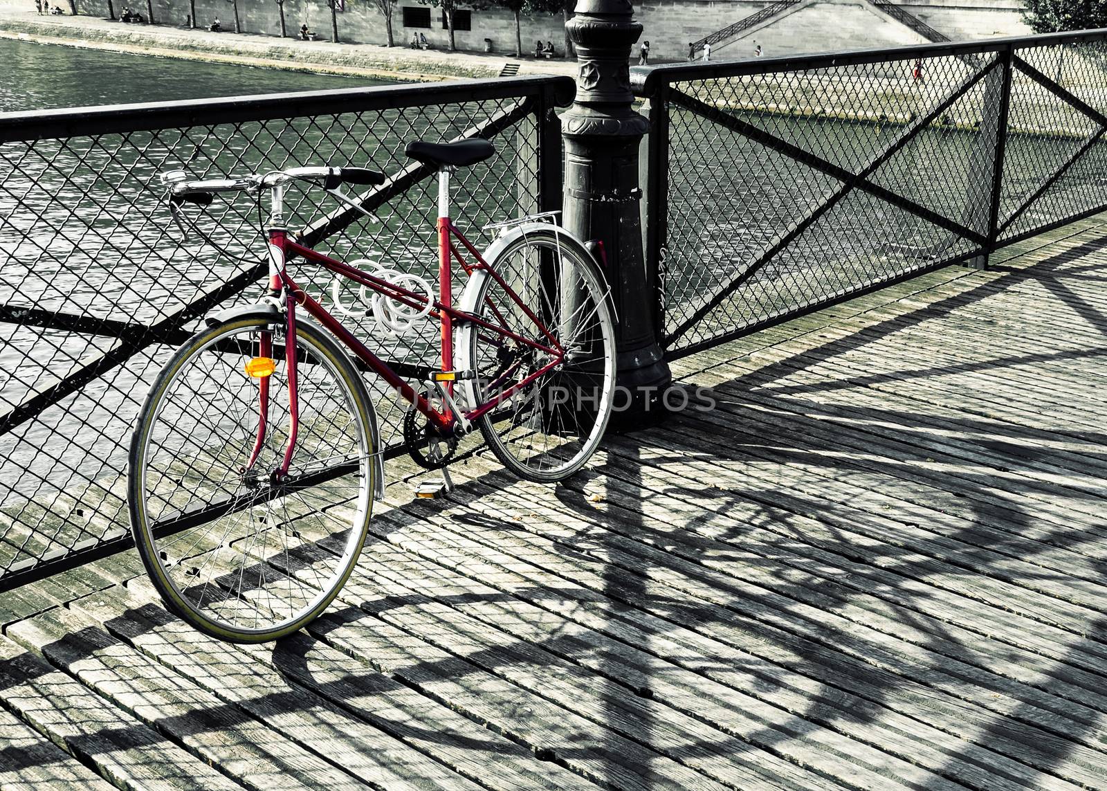 Vintage red bicycle on Pont des Arts in Paris, France
