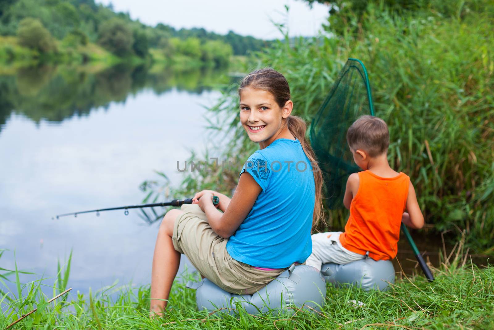 Summer vacation - Sister and brother fishing at the river