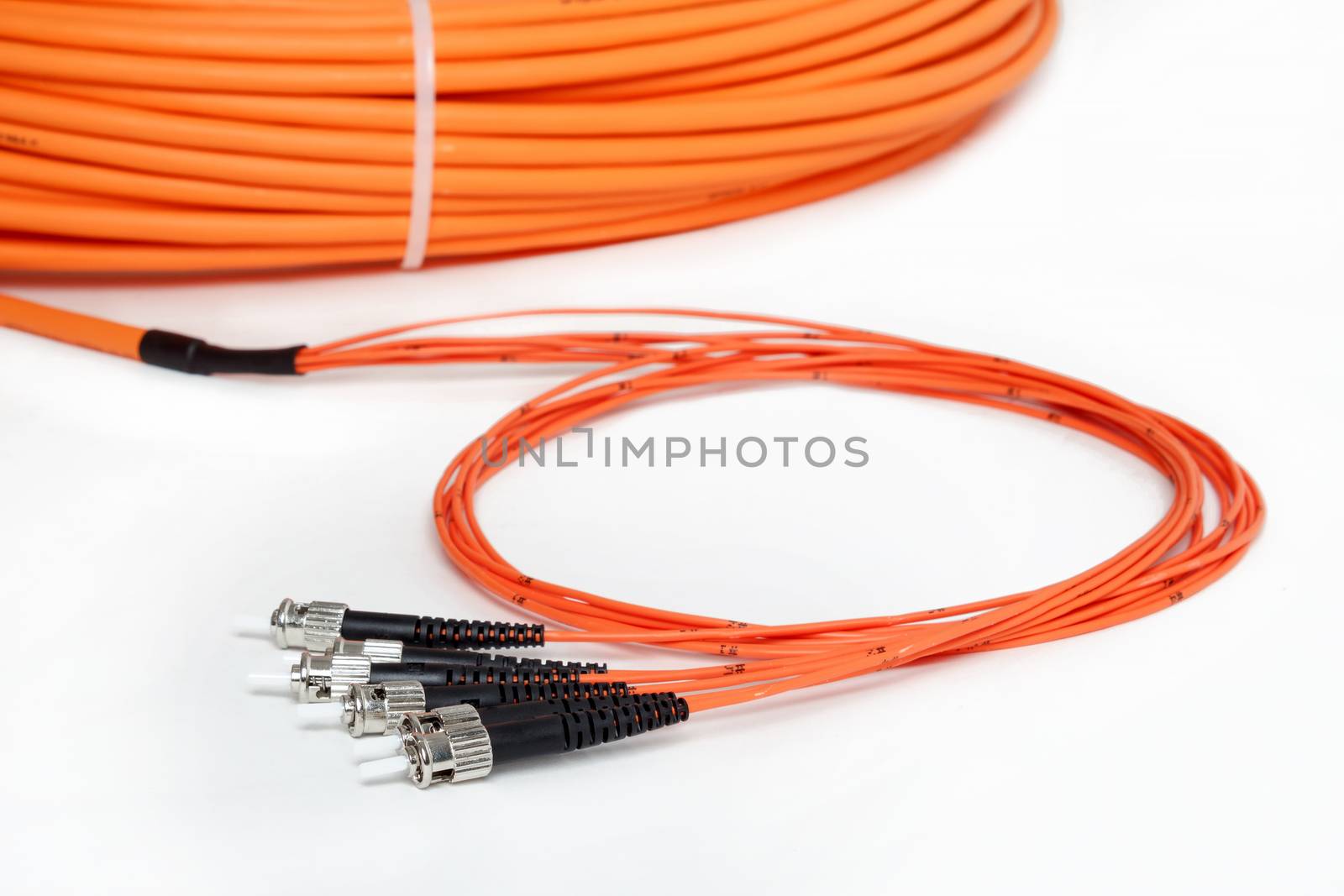 group of fiber optic ST connectors on orange patchcord 