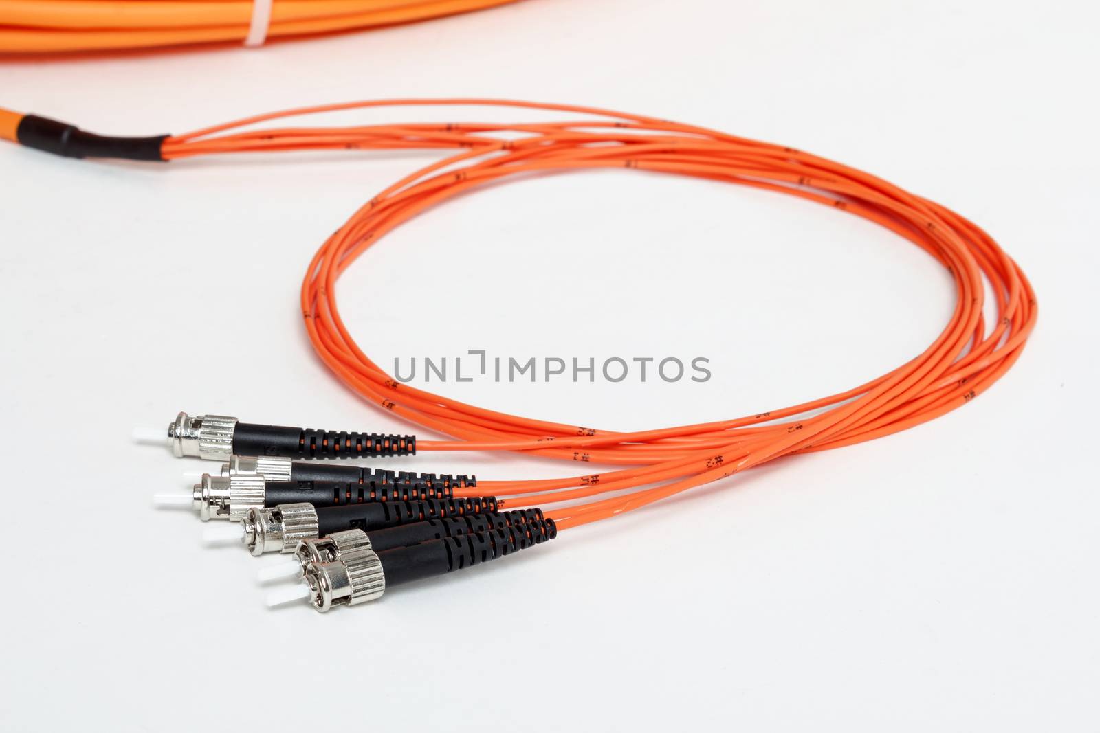 group of fiber optic ST connectors on orange patchcord 