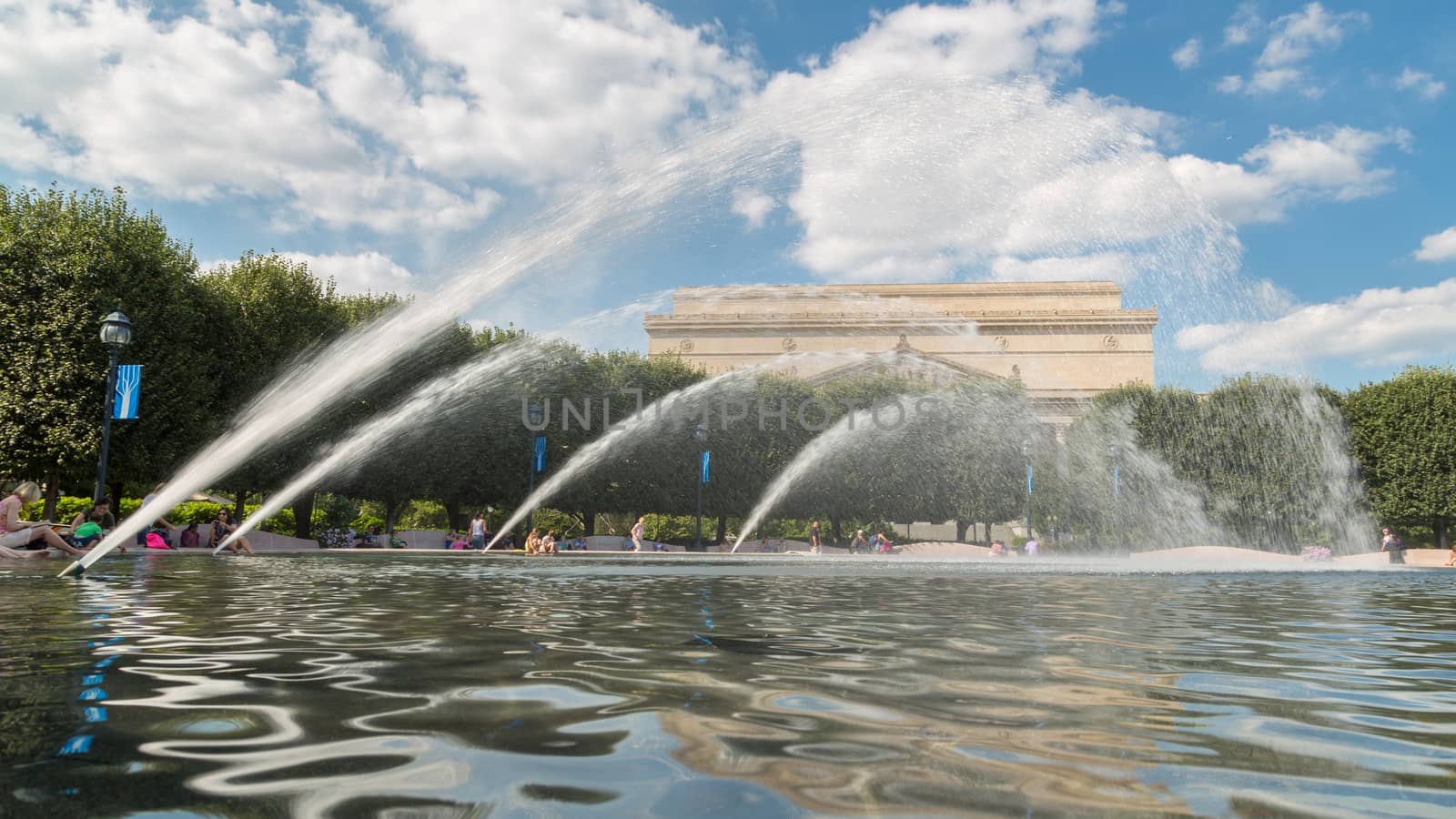 Washington DC - Aug 26: Tourists and residents of Washington DC cool off at the fountain in front of the Archives of the United States of America building on August 26, 2014, Washington DC, USA