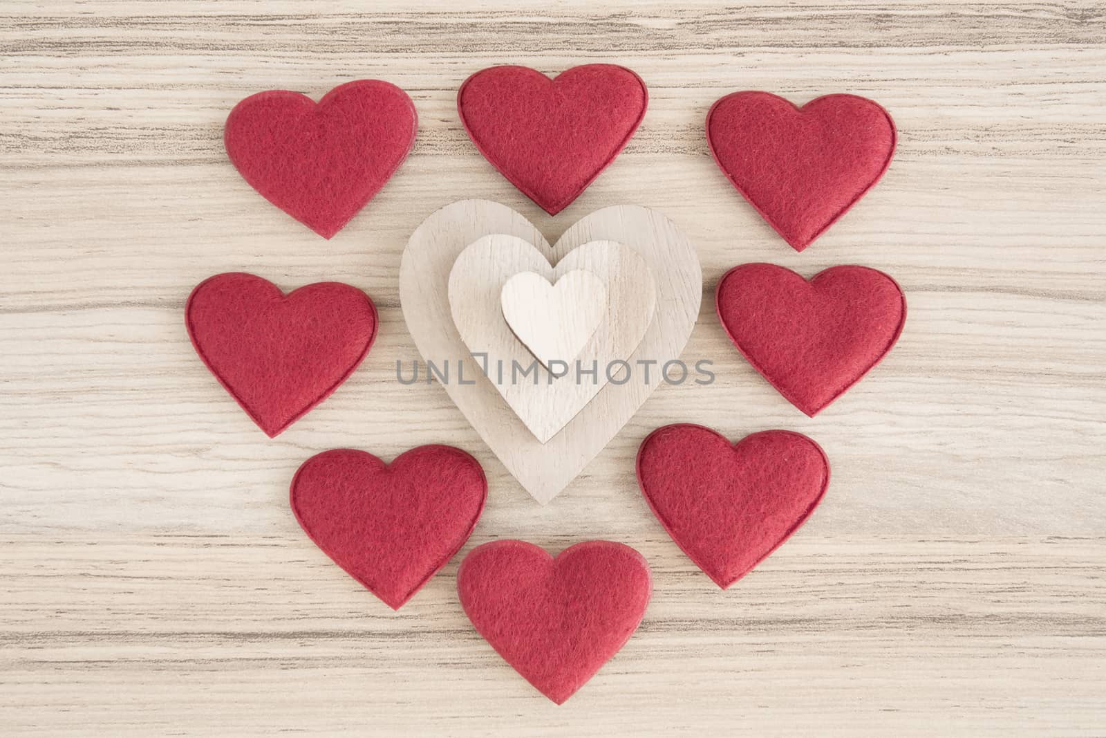 valentine's wooden and fabric hearts on a wooden background , valentine's day , day valentine postcard with space for text