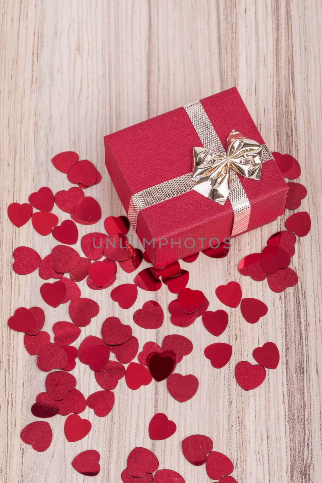 small red hearts confetti and present box full of hearts, valentine love concept