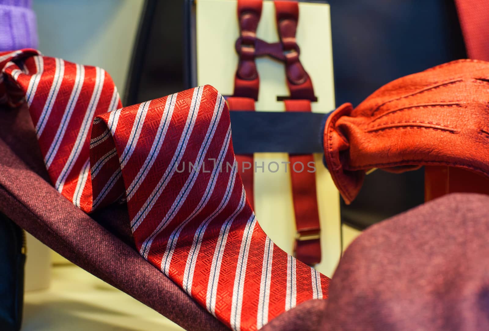 View of striped necktie and red gloves in the clothes shop