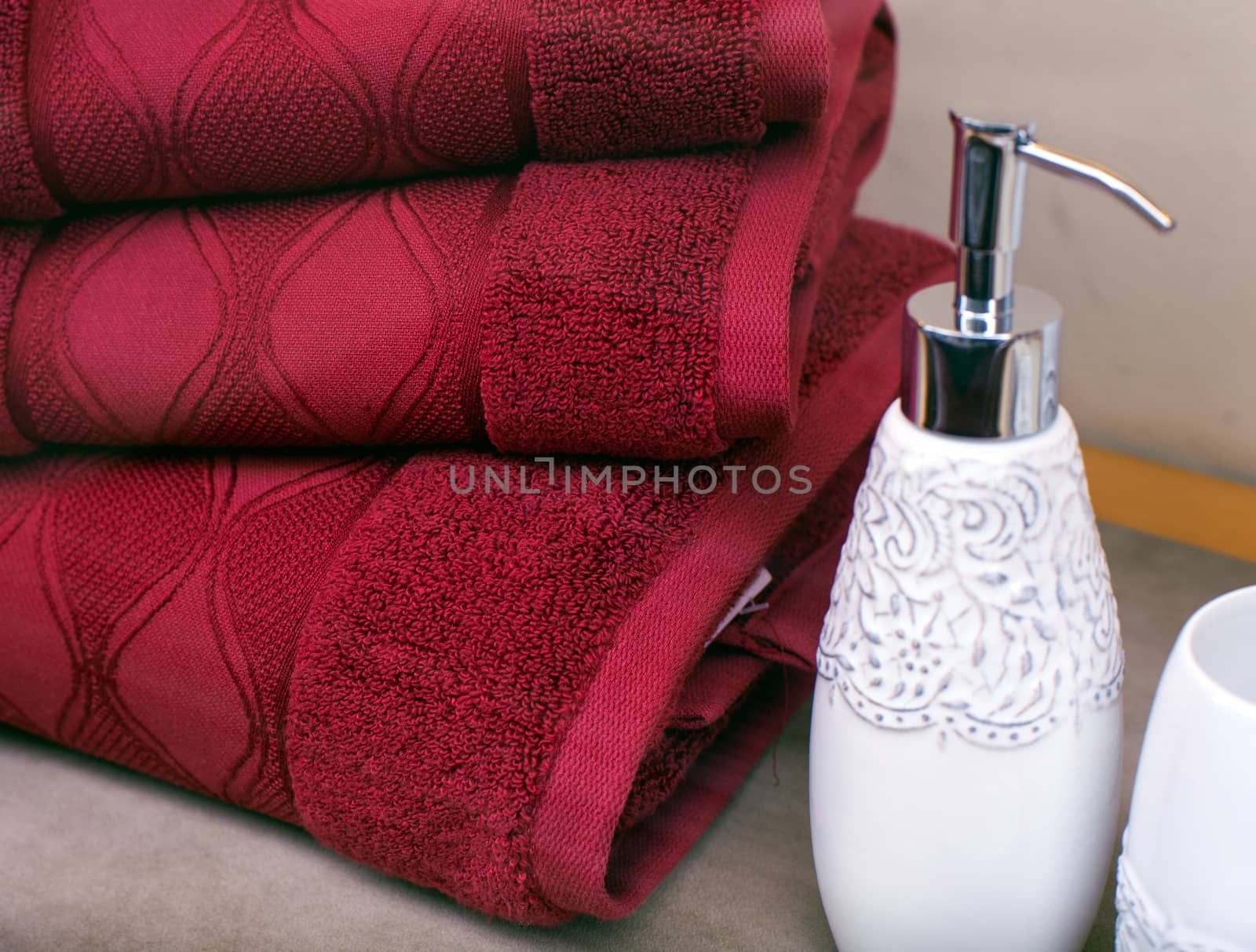 Stack of towels and liquid soap bottle