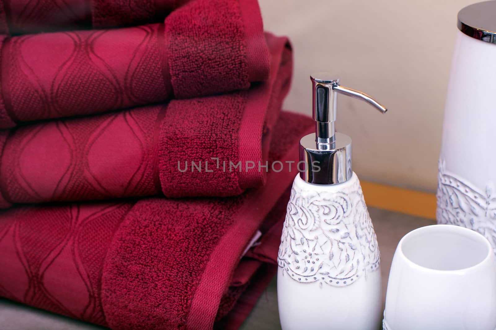 Stack of towels and liquid soap bottle