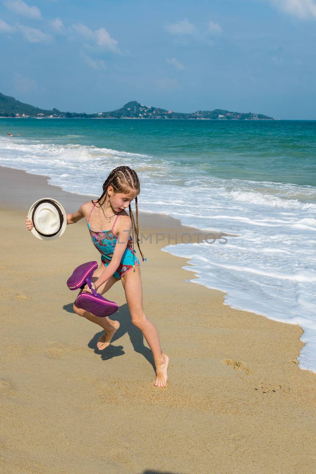 little girl on the sunny sea beach