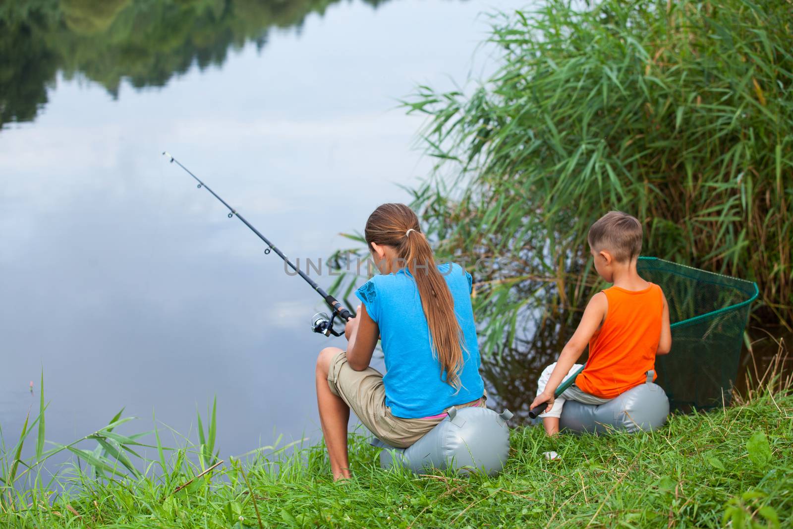 Summer vacation - Sister and brother fishing at the river