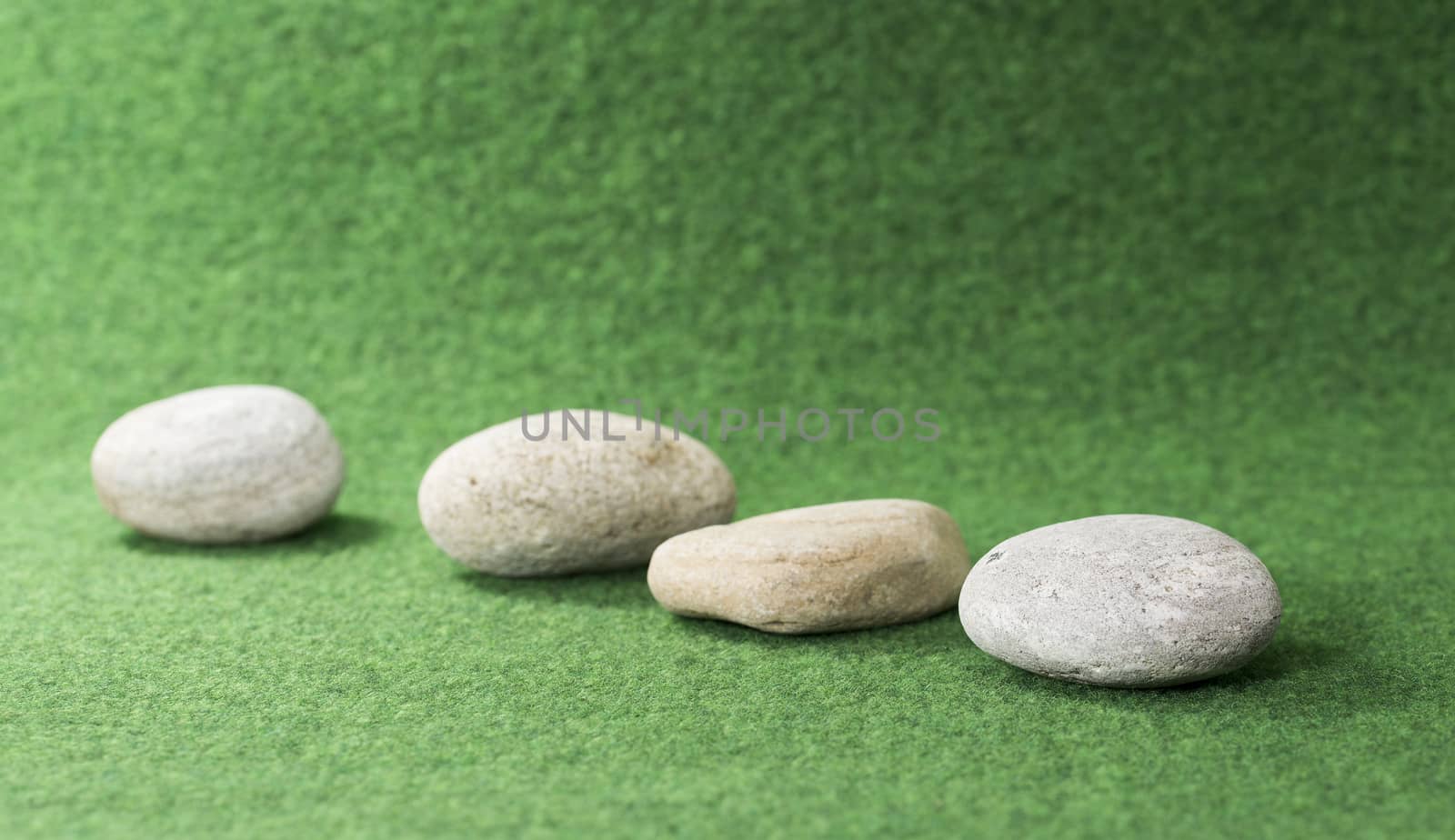 row of stones on green background