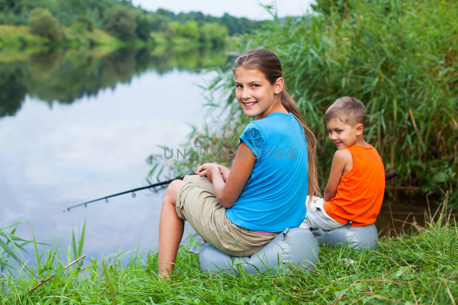 Summer vacation - Sister and brother fishing at the river