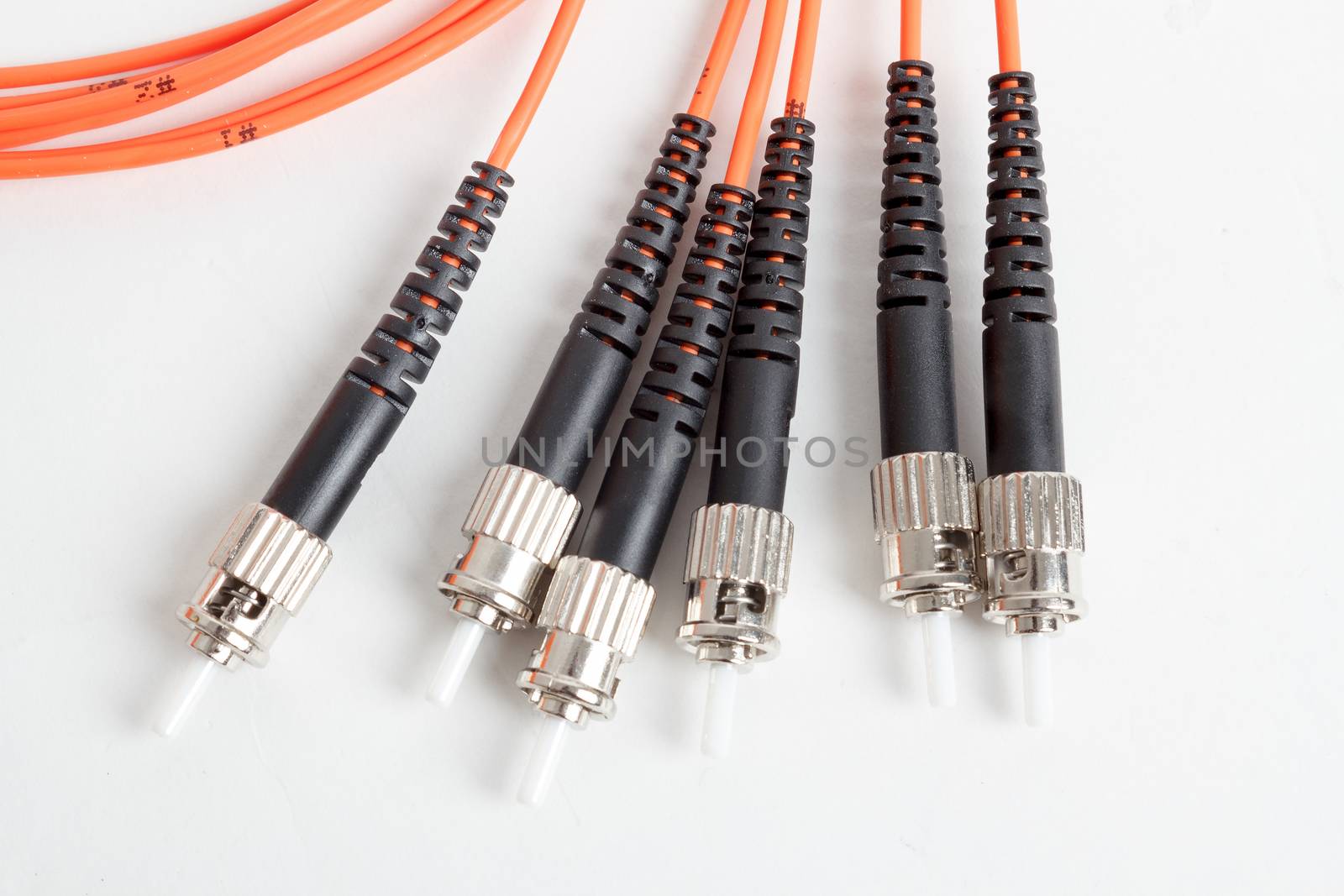 group of fiber optic ST connectors on orange patchcord 