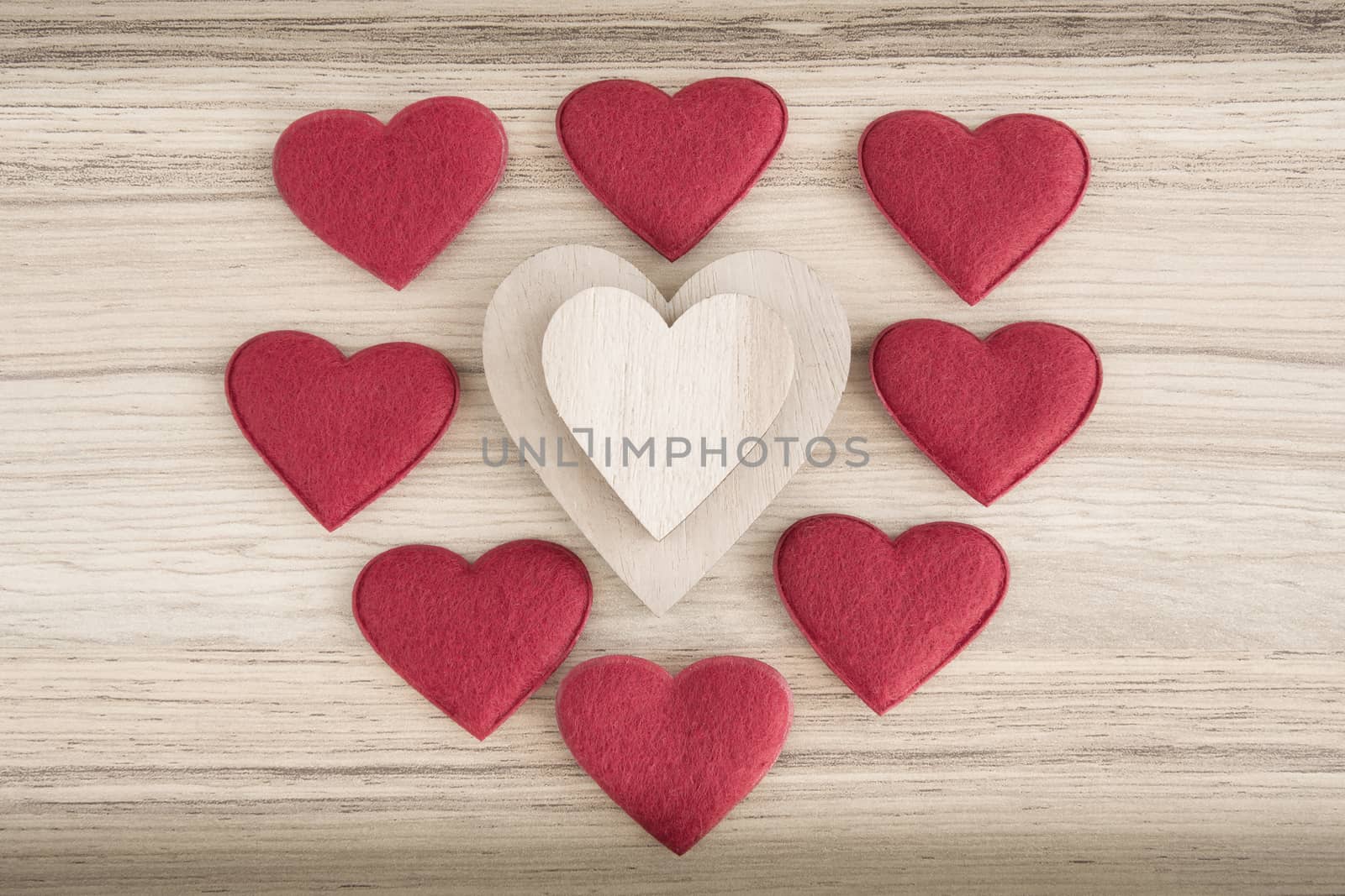 valentine's wooden and fabric hearts on a wooden background , valentine's day , day valentine postcard with space for text