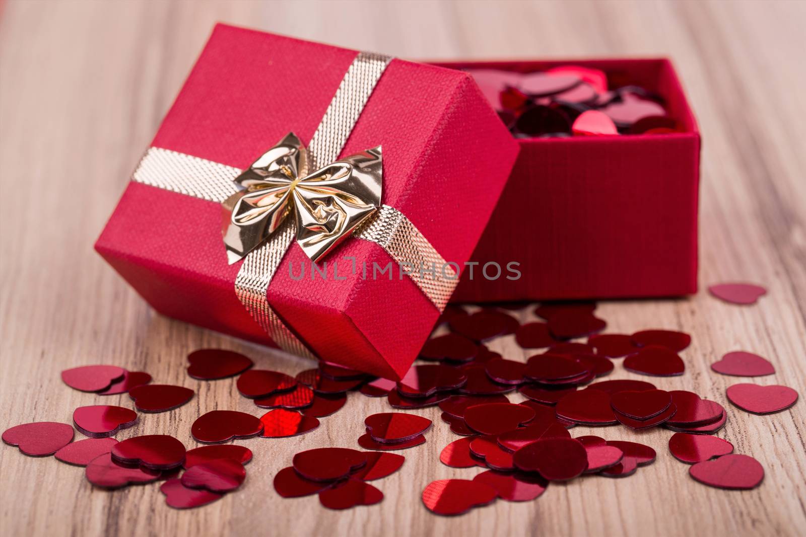 small red hearts confetti and present box full of hearts, valentine love concept
