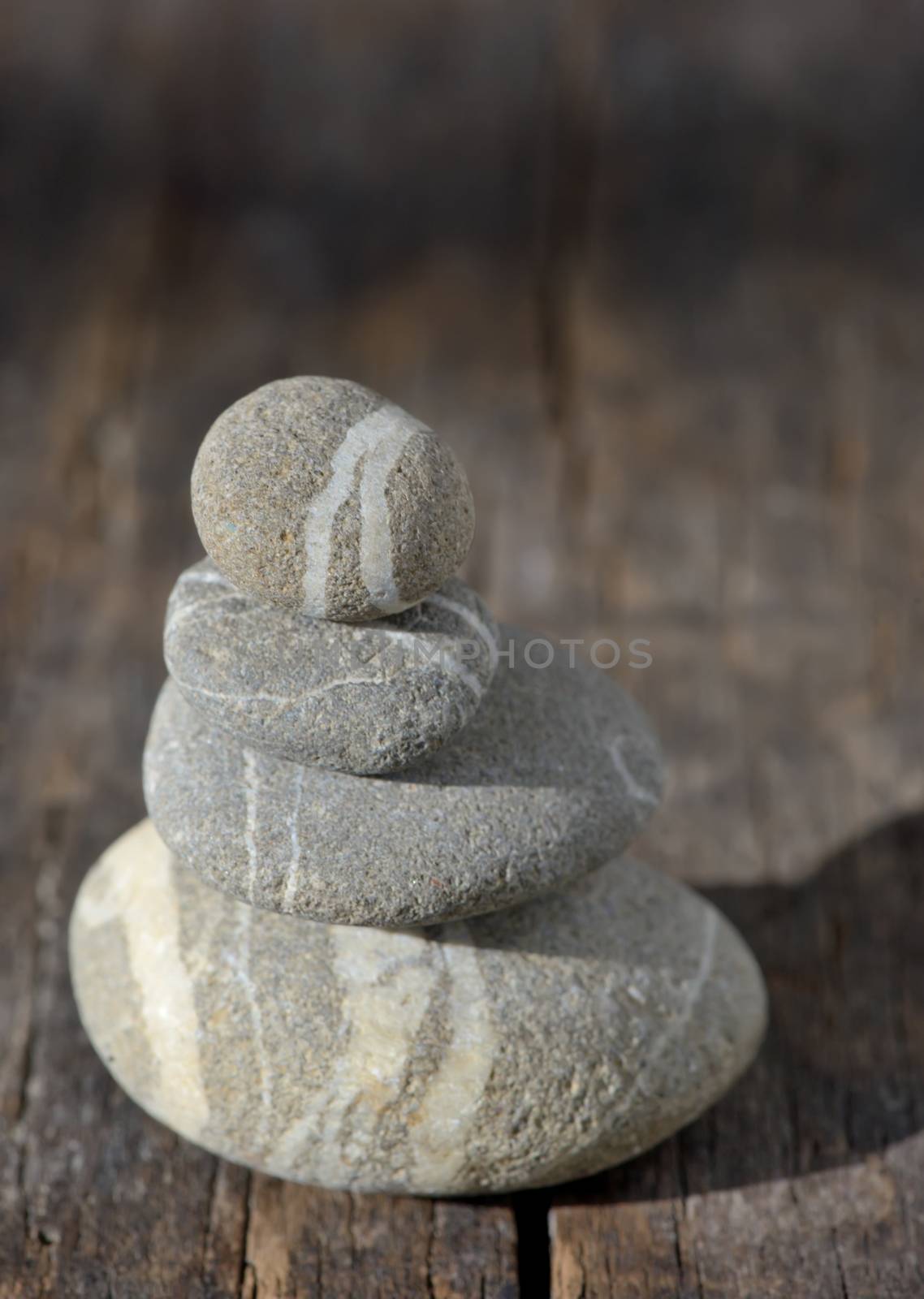 Stones pyramid on wooden symbolizing zen, harmony, balance