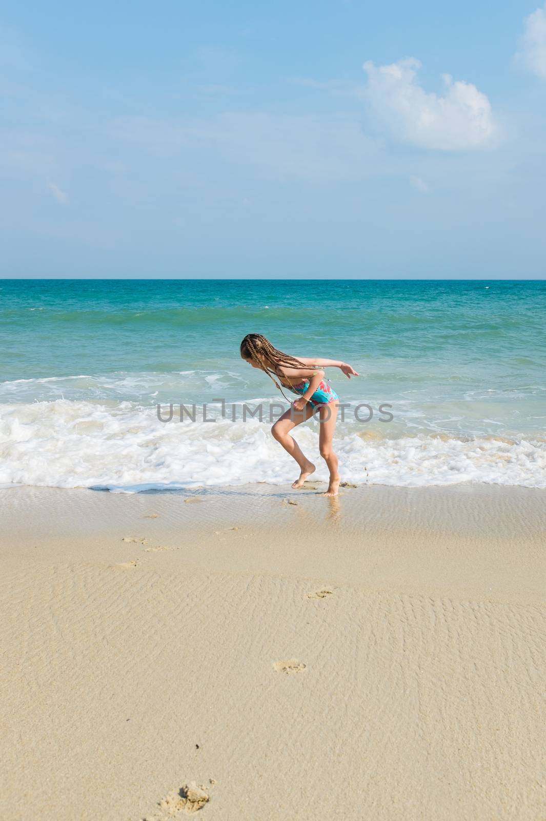 little girl on the sunny sea beach