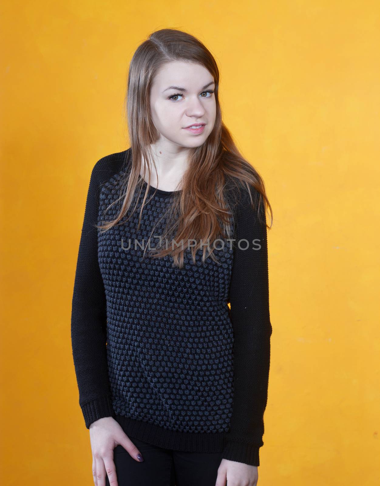 portrait of a beautiful  girl on a background of orange wall