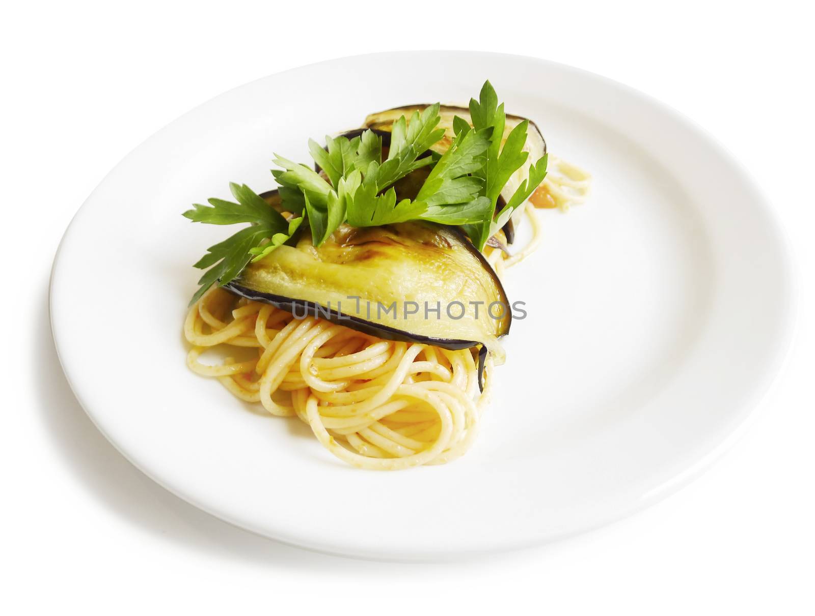 Traditional Italian cuisine. Close-up of pasta spaghetti roll with aubergine, fresh tomatos and parsley. On white background.