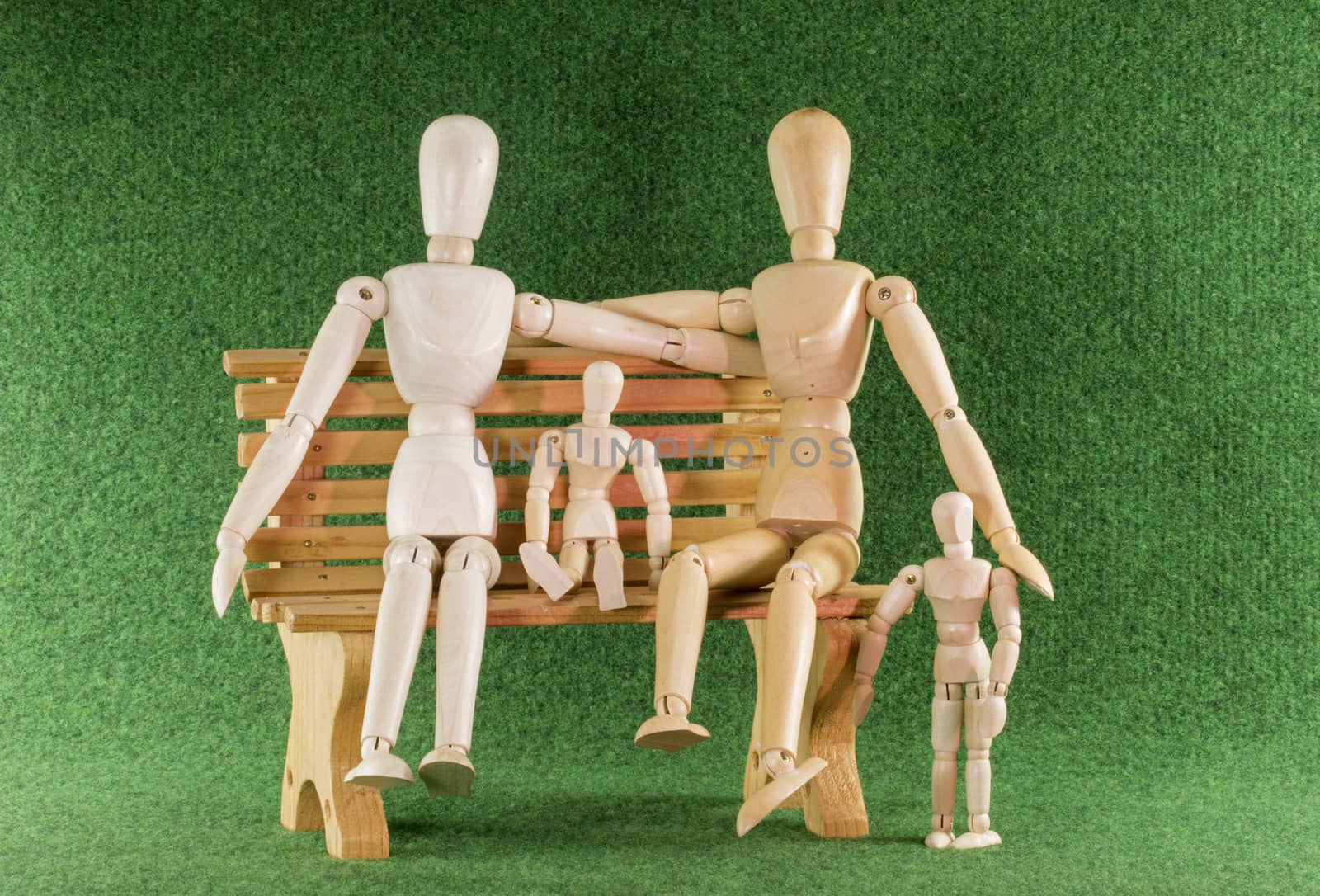 happy family with children in wooden play puppets on bench