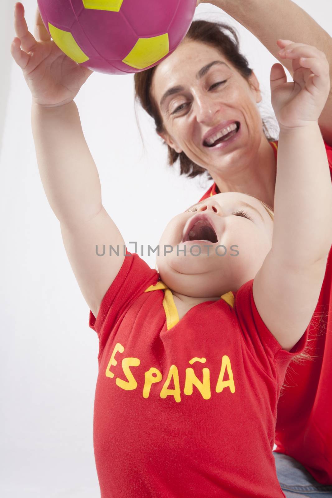 blonde baby sixteen month old and mother with red shirt of Spanish soccer team with ball