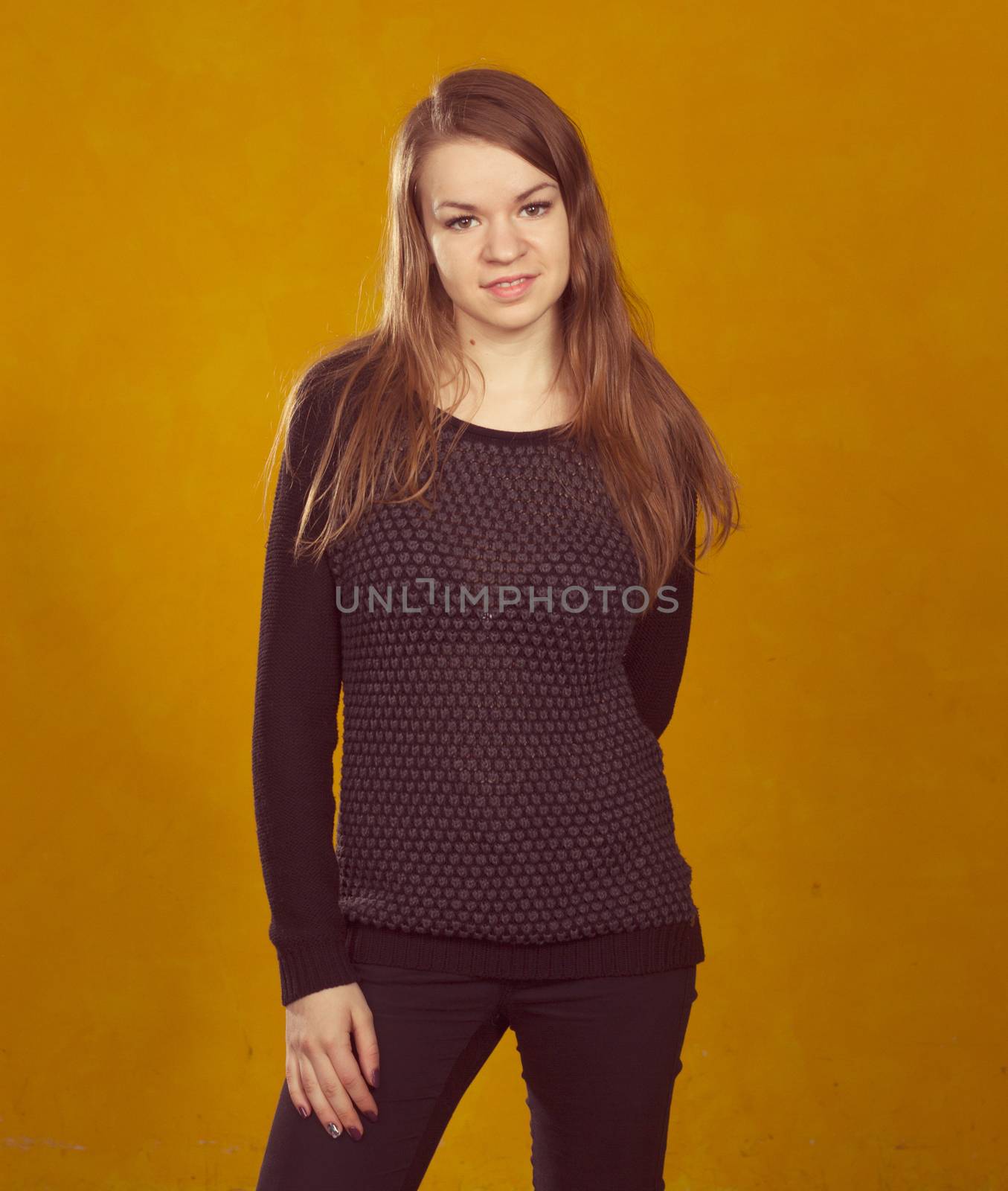 portrait of a beautiful  girl on a background of orange wall