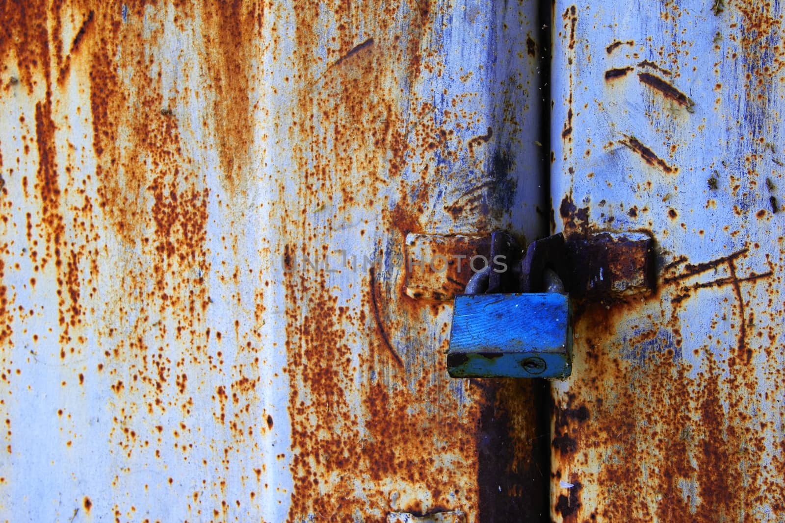 very old metal door with padlock