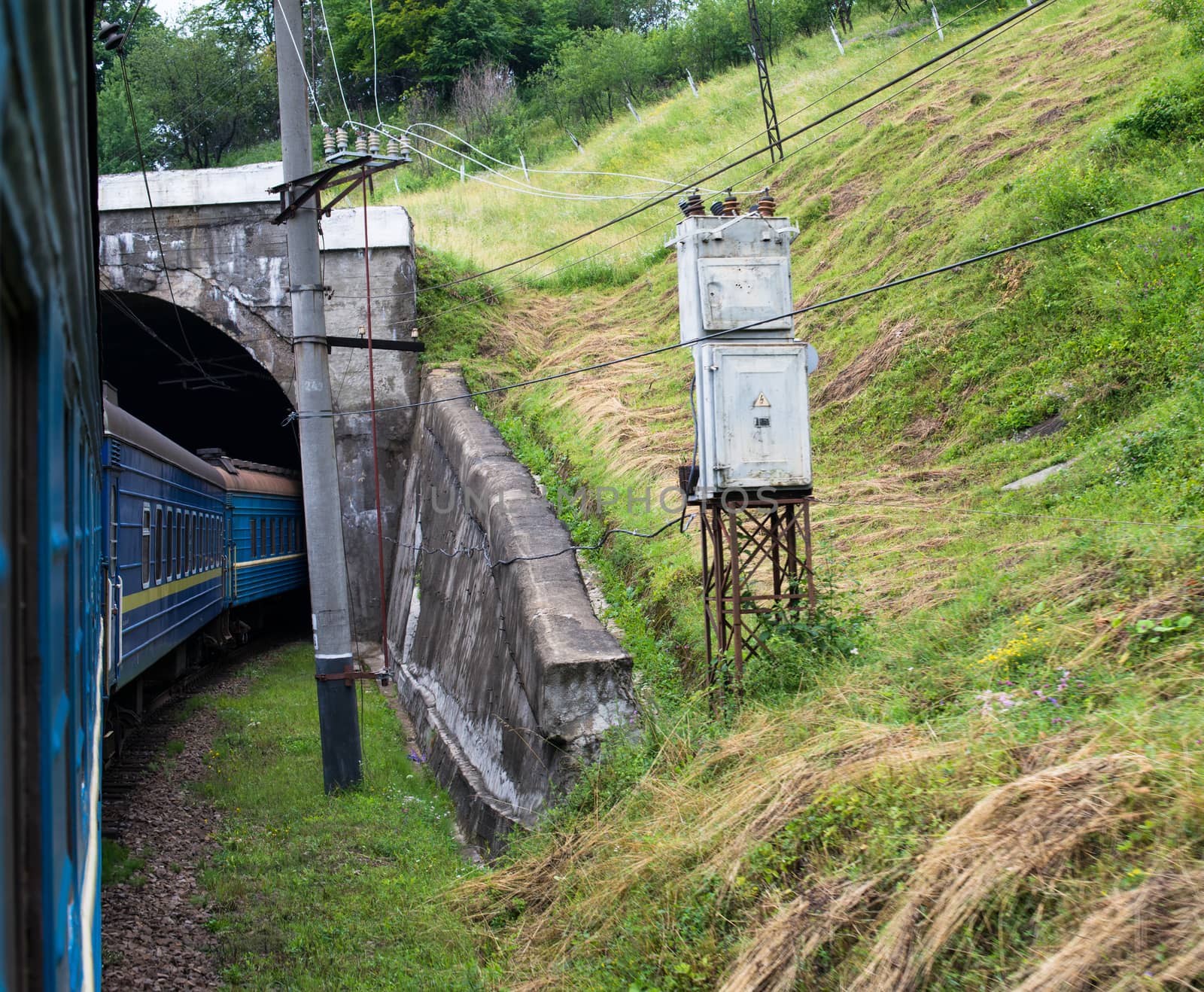 Passenger train going into the tunnel in the Carpathian Mountains