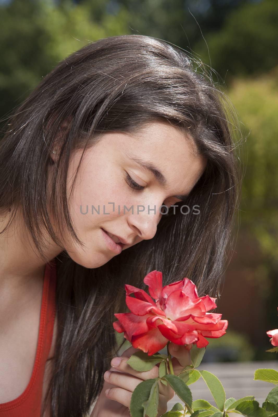 smelling red flower by quintanilla