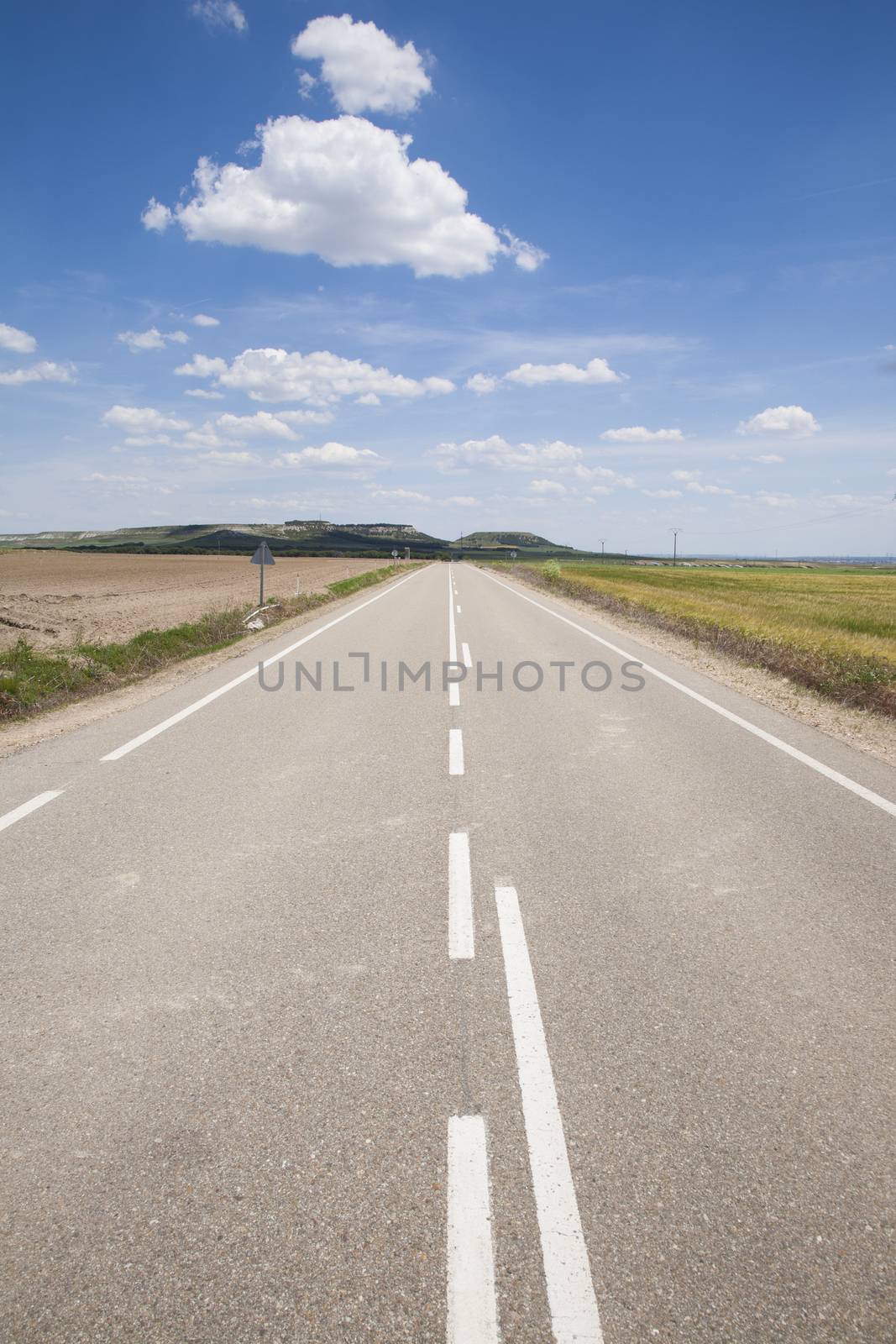 landscape straight rural grey lonely road in countryside of Spain Europe