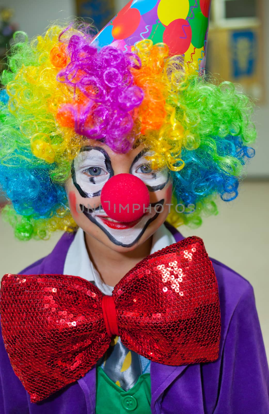 Close-up portrait of cute little boy clown