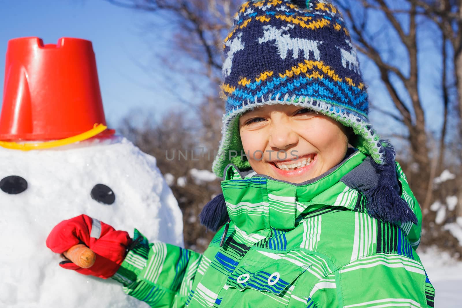 Winter, play, fun - Little boy making a snowman