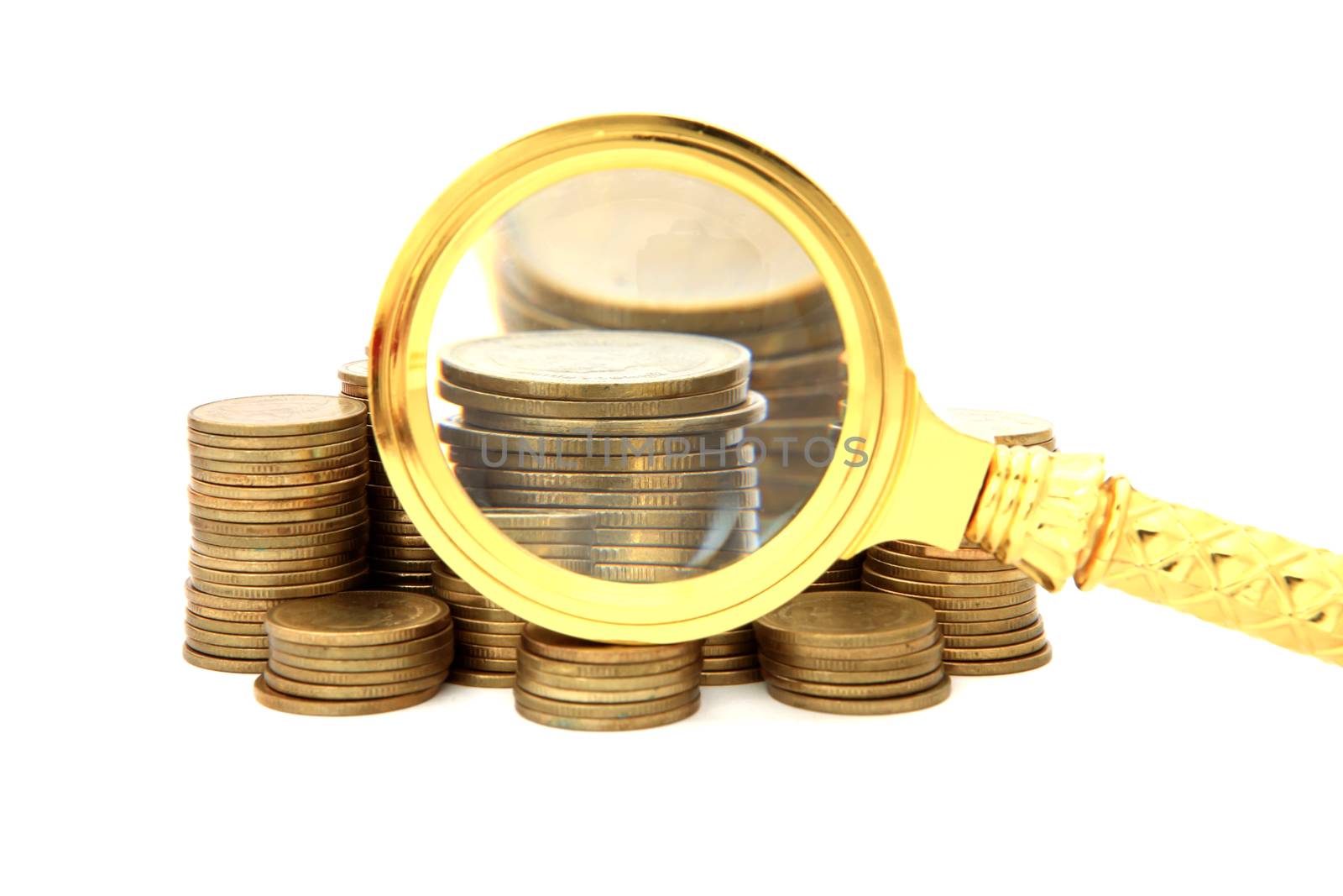 Magnifier and gold coins. On a white background.