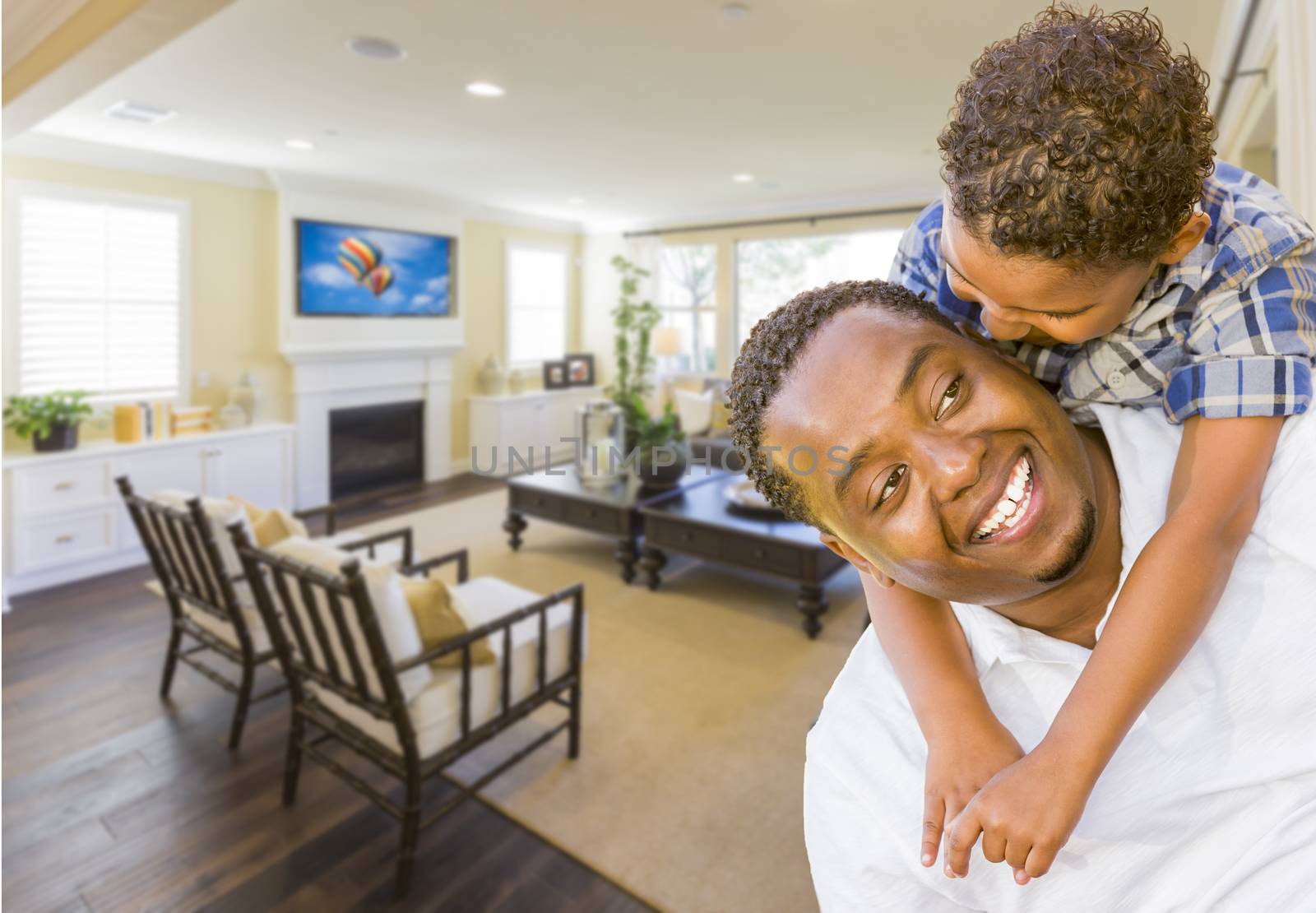 Playful African American Father and Mixed Race Son in Living Room of House.