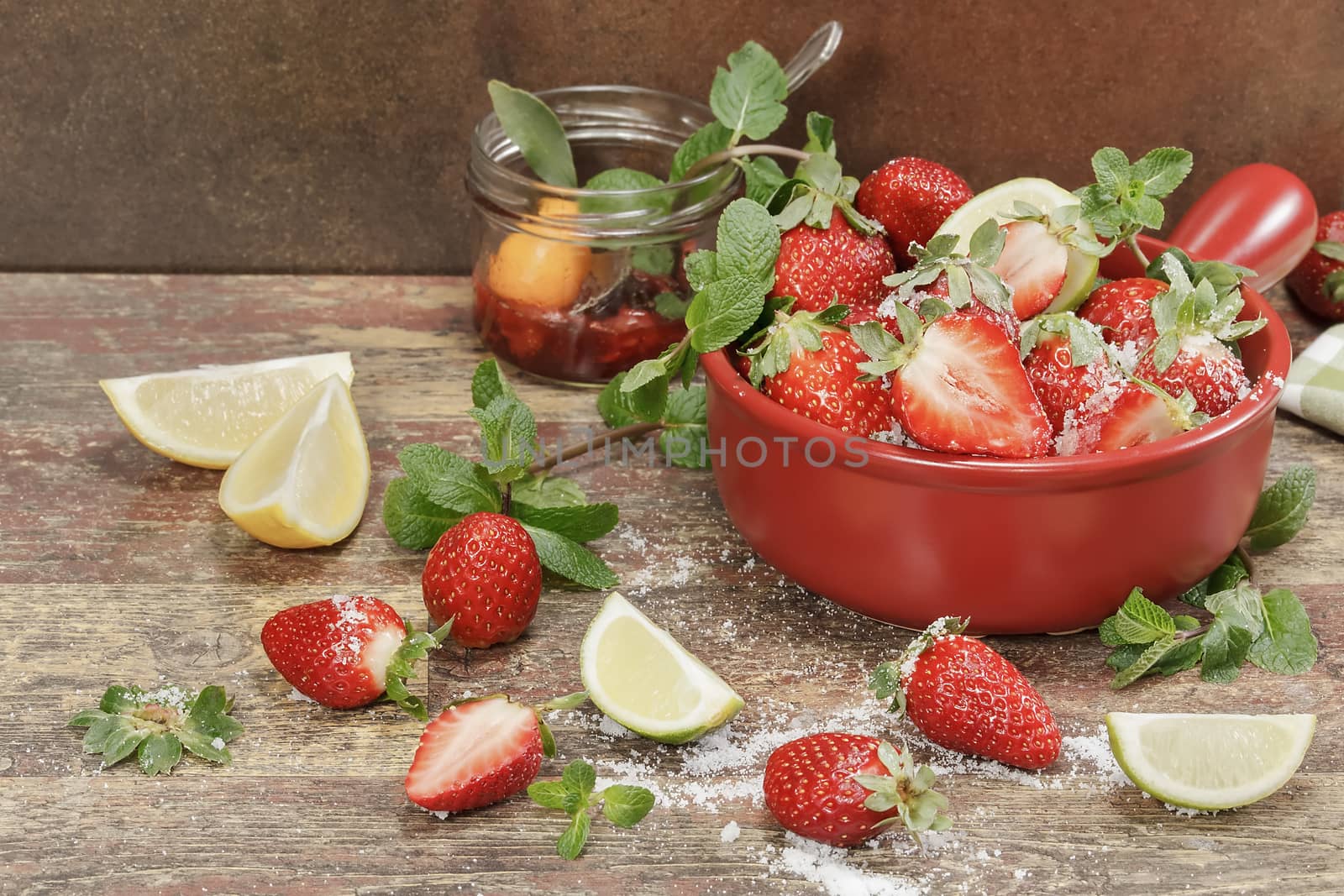 Making strawberry jam, stirring strawberries and sugar and fresh fruits on a background of rustic wood. Copy space . Macro, selective focus