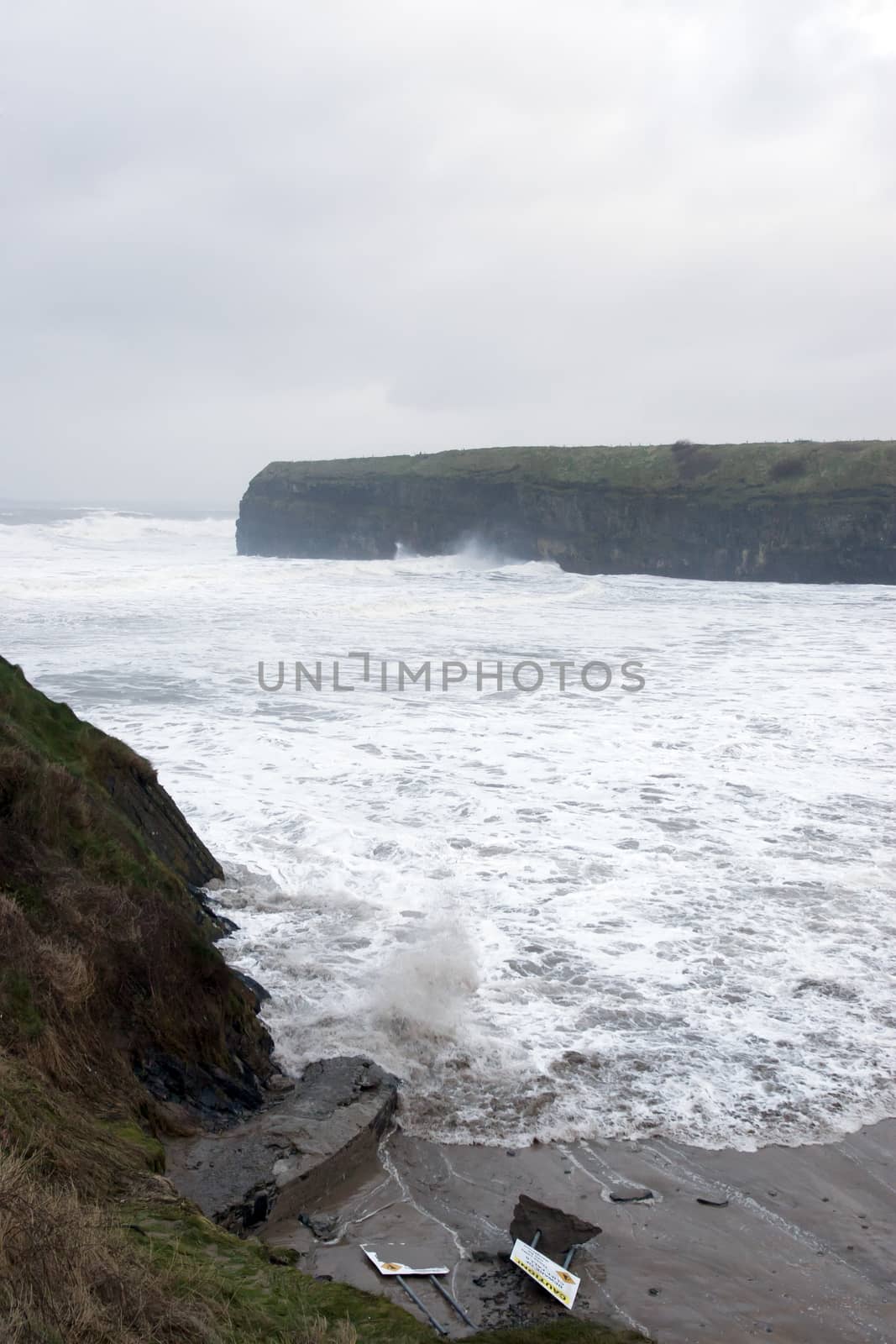 Ballybunion seaside beach and cliffs during a very bad storm with crashing waves