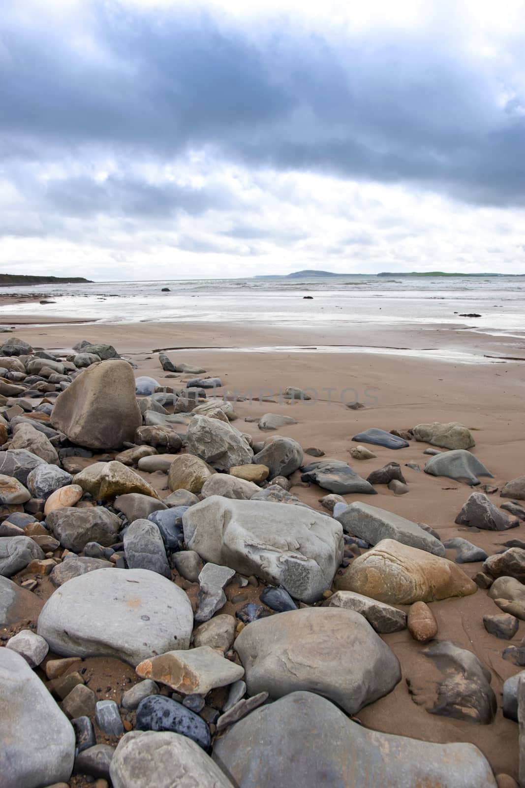 storm clouds over rocky beal beach by morrbyte