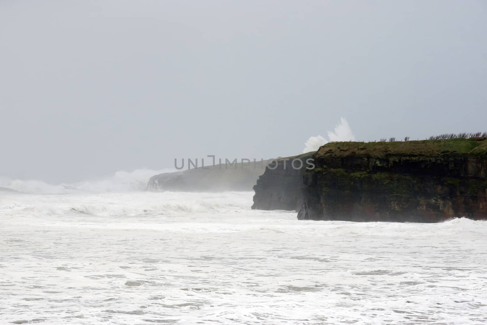 Ballybunion seaside beach and cliffs during a very bad storm with crashing waves